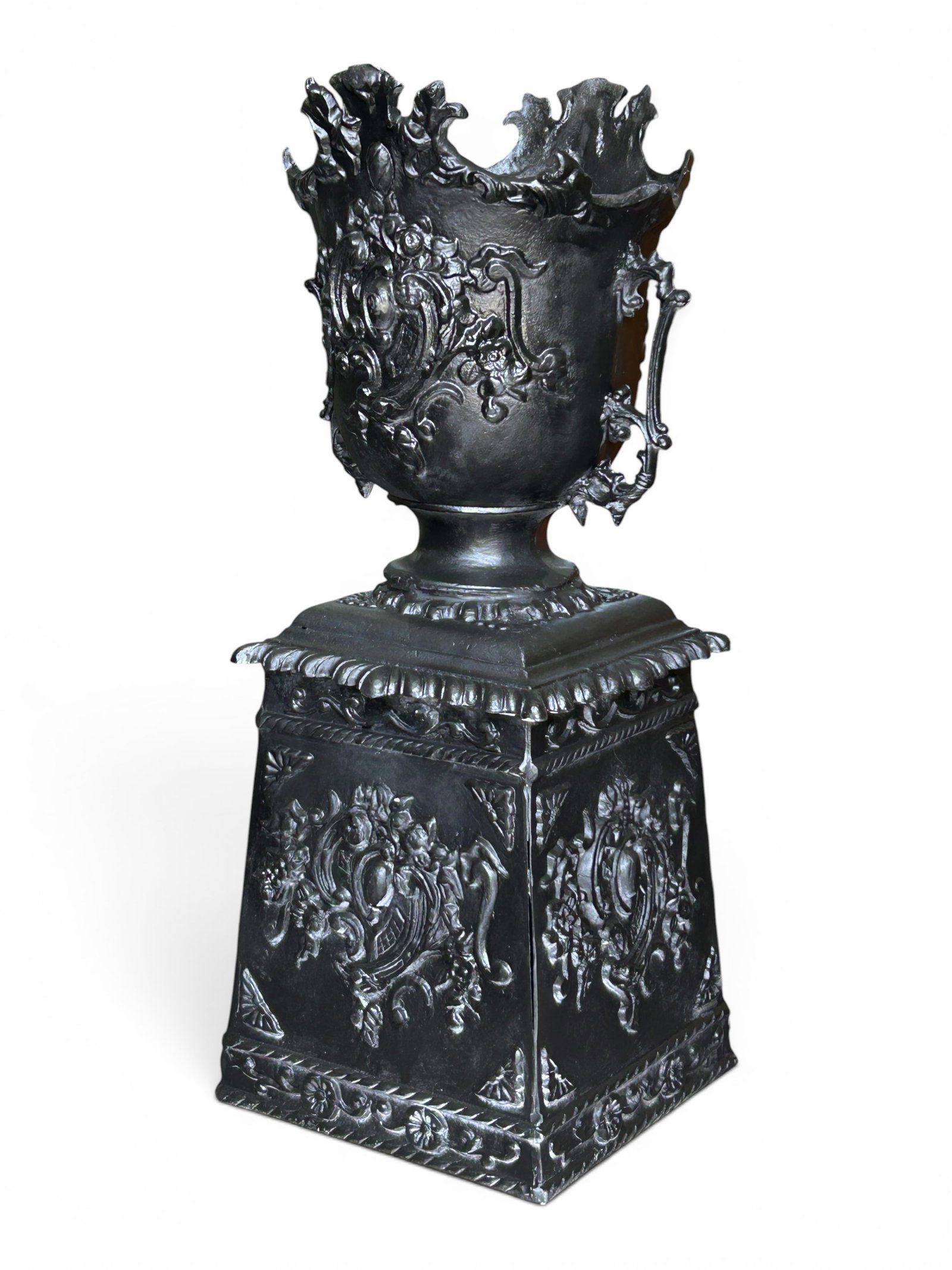 Ornate Black Aluminum Garden Planter.: The cast aluminum garden planter is stamped Mexico on the inside of the pot. It measures 40 1/4" tall, 18 1/2" wide, and 16 1/4" deep. There are some scratches on the piece. Otherwise, it is in
