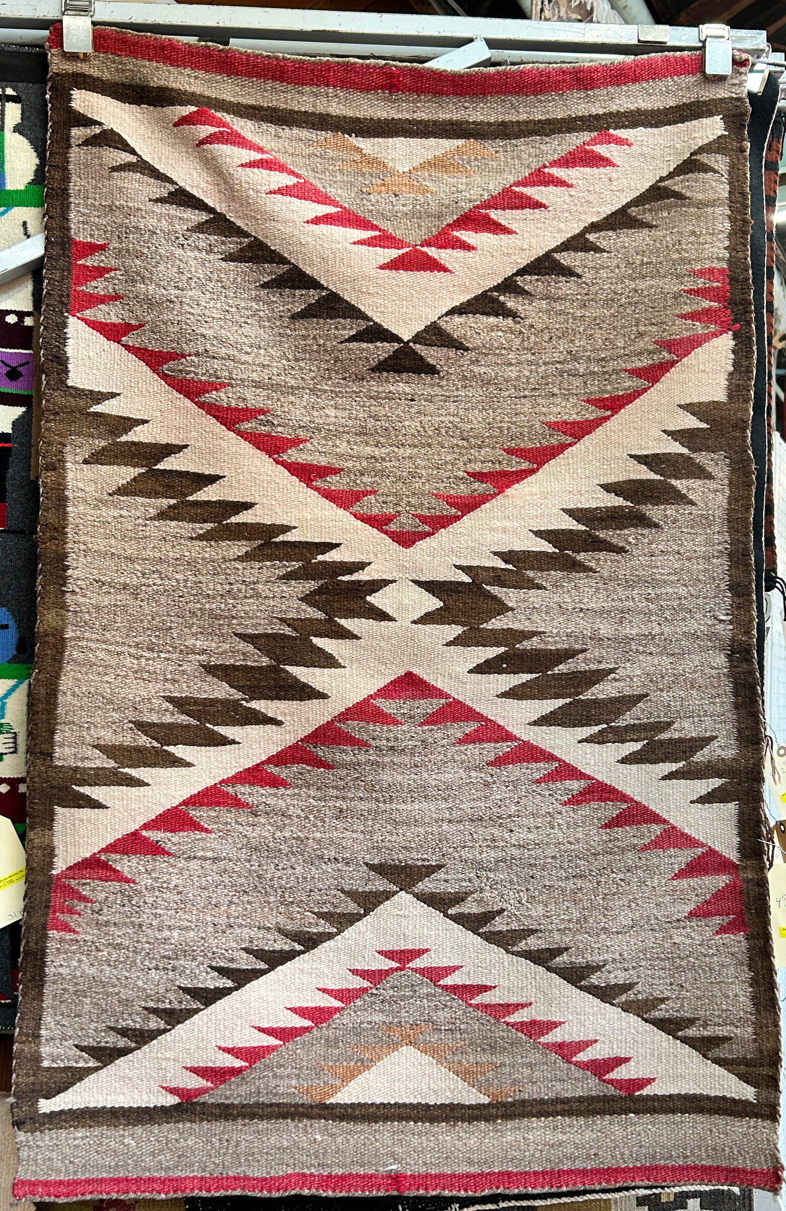 2' 10" x 4' 5" Older Eye Dazzler Navajo Rug.: The rug has a repair in its lower right quadrant, but is in otherwise good overall condition. In-House Shipping is available for this rug. Please see our website for our in-house shipping procedures.