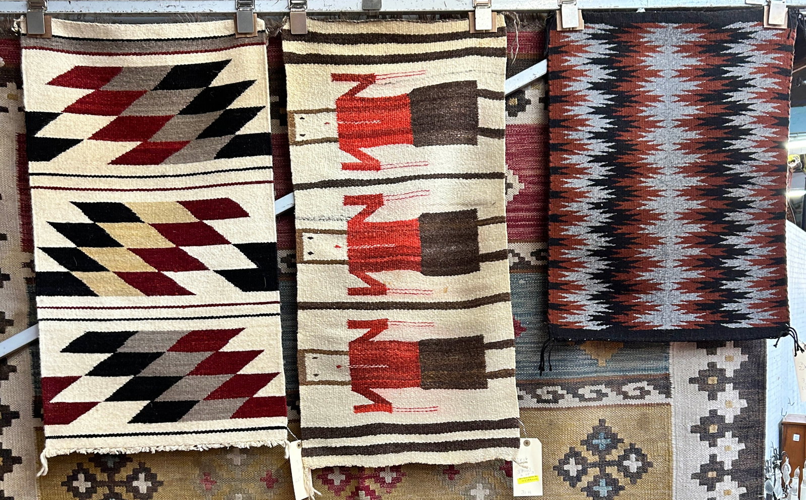 Lot of 3 Smaller Navajo Rugs.: The yei rug looks to be on the older side; the other two rugs are newer. They measure 1' 8" x 2' 2", 1' 6" x 3', and 1' 7" 2' 10". All of the rugs look to be in good overall condition. In-House Shippi