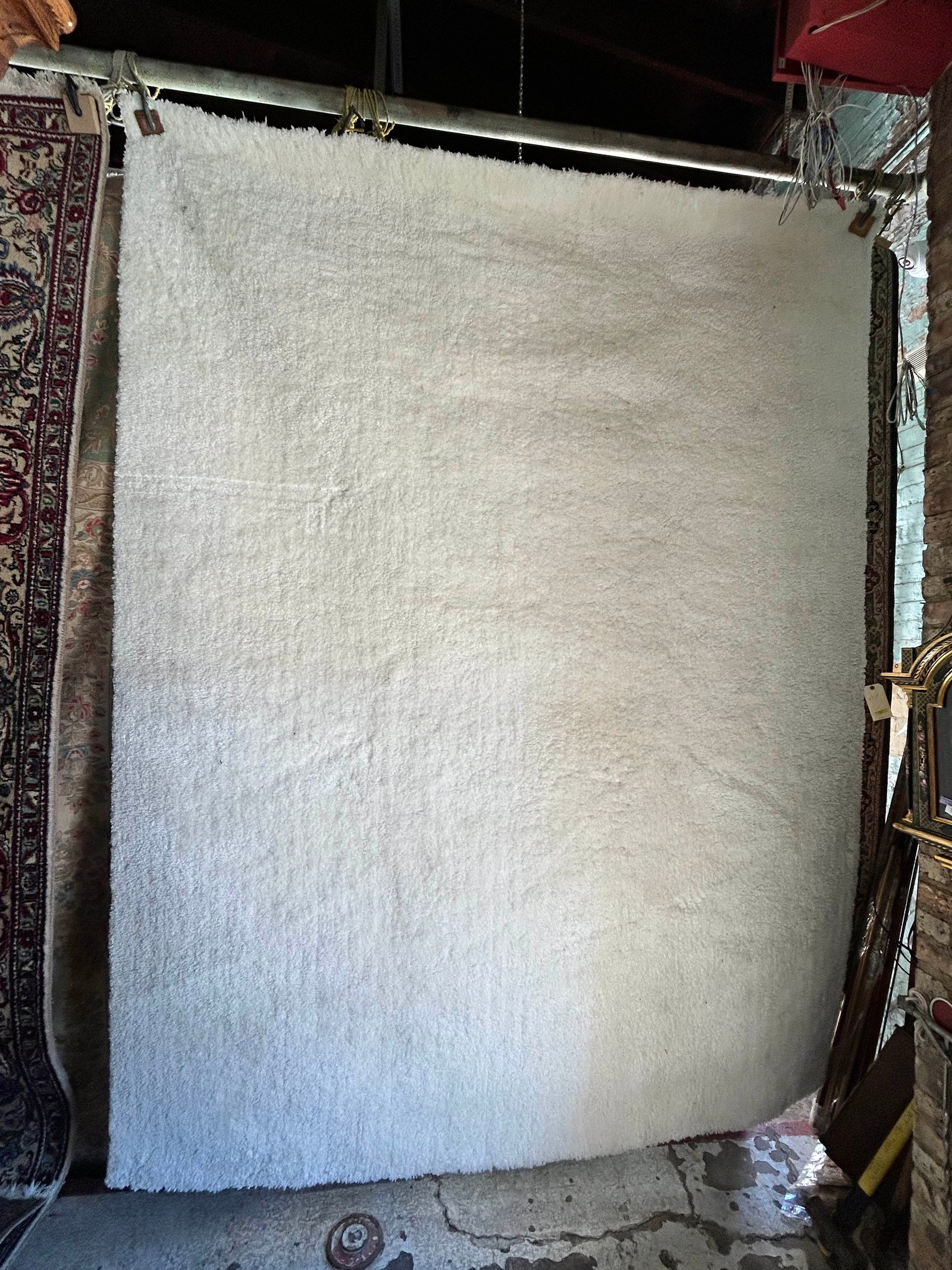 7' 8" x 10' 2" Nicole Miller White / Beige Rug.: This area rug has a couple of dirt spots in one corner, but is in good overall condition otherwise. In-House Shipping is available for this rug. Please see our website for our in-house shipping proced