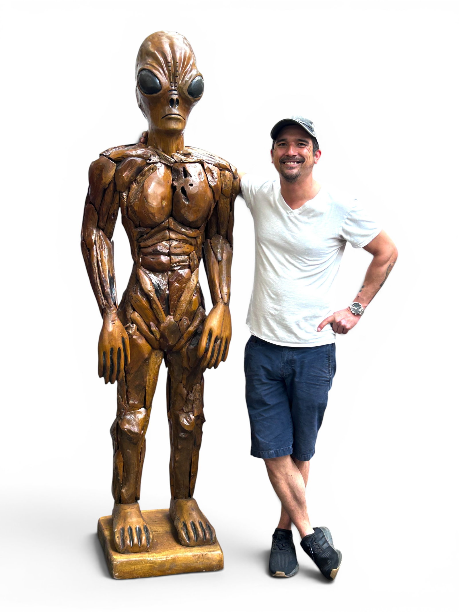 Large Teakwood Alien Extraterrestrial Sculpture.: The sculpture is composed of reclaimed and carved teakwood. It measures 81 1/2" tall, 24 1/2" wide, and 17" deep. There are some scratches, scuffs, and stains on the piece. Otherwise, it is in