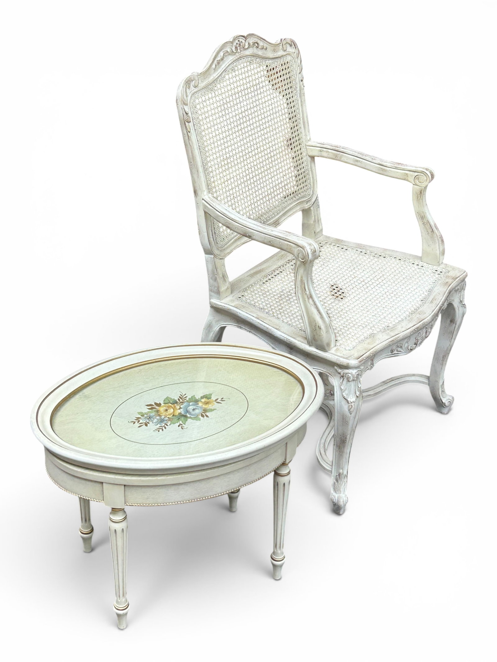 Carved Cane Chair & French Painted Tray Table.: The lot contains 2 pieces of carved wood furniture that have been painted white. The chair has a Made in Spain sticker. It has fan and scroll carvings on the top, the arms, the apron, the front legs,