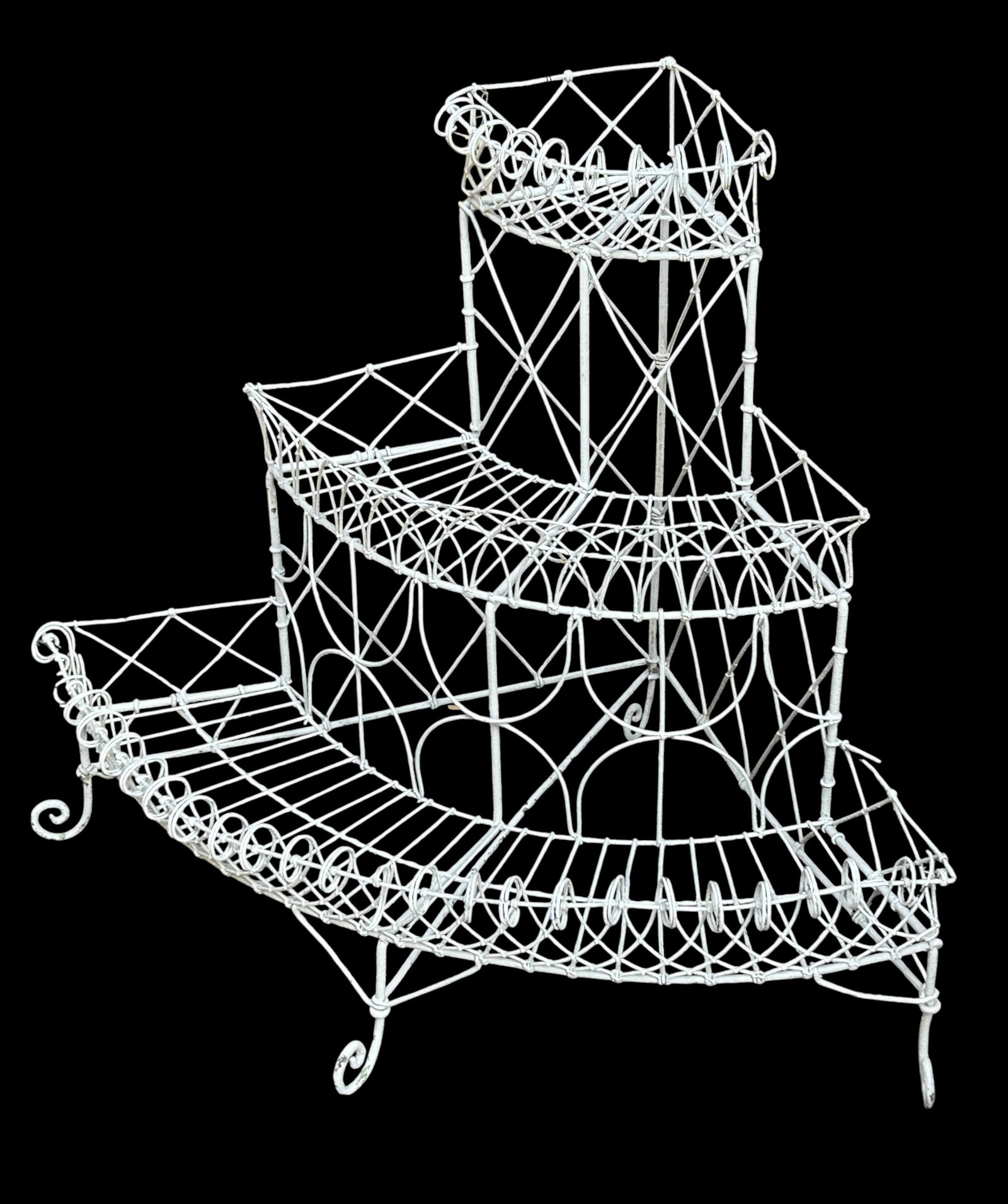 Wire & Wrought Iron 3-Tier Corner Plant Stand.: The plant stand has scrolled wrought iron legs. It is painted white. It measures 33 1/4" tall, 41 1/2" wide, and 29 3/4" deep. There are some scratches, stains, paint loss, and bent wires on the