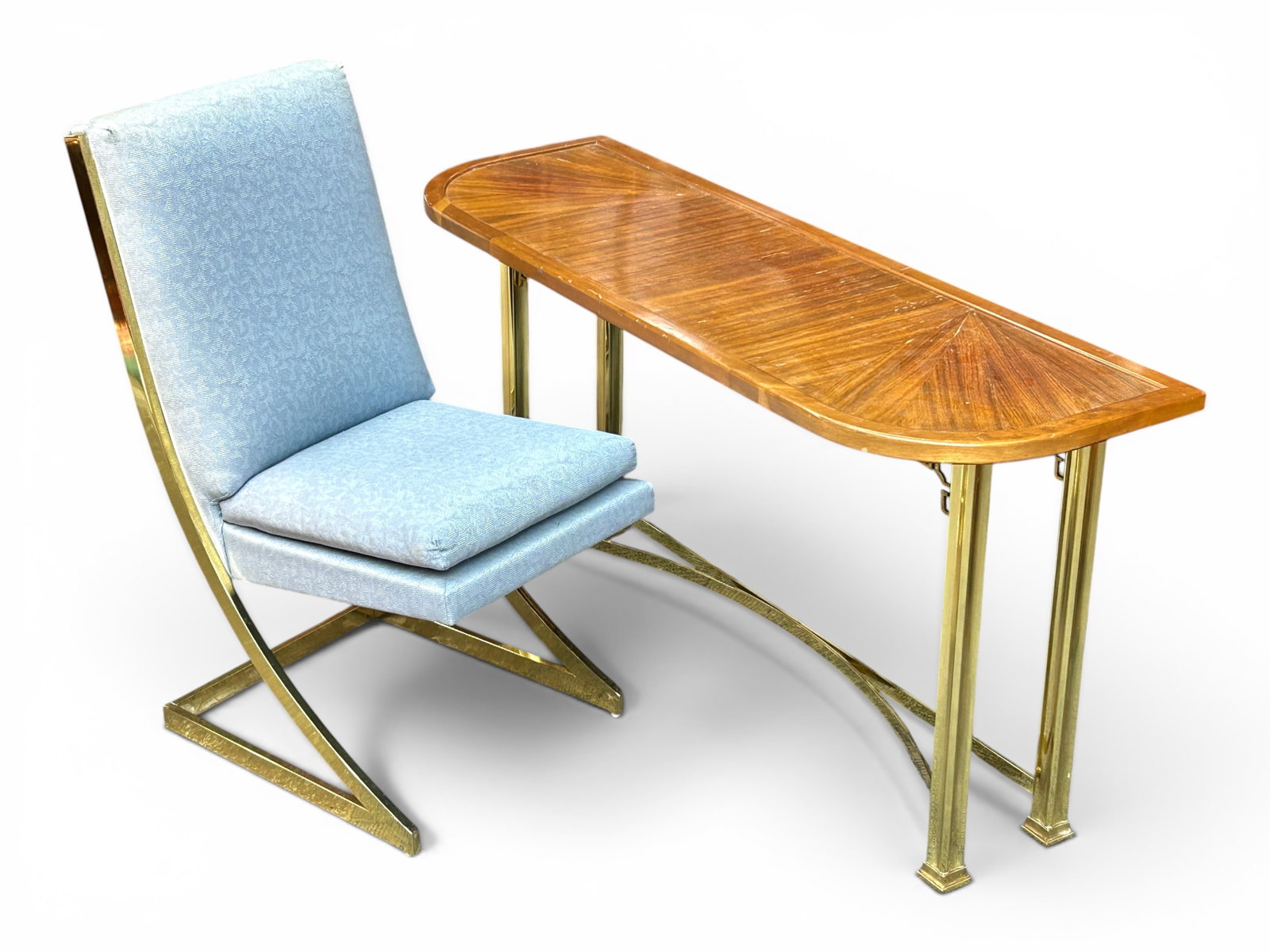 Post Modern Wood & Brass Desk & Milo Z Chair.: The lot contains a desk and matching chair. The desk has a polished brass base with chinoiserie details on the inside corners, and a wooden top with a sunburst style veneer and rounded corners. The ch
