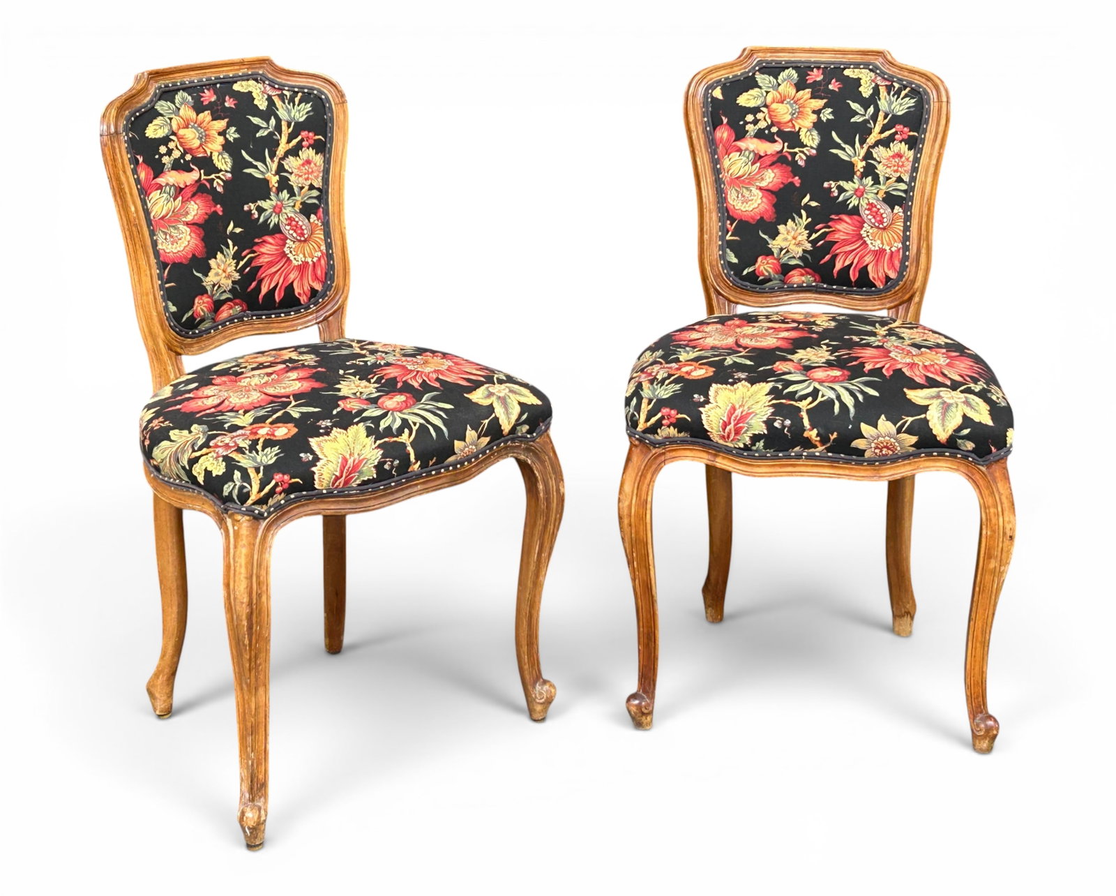 Pair of Carved Louis XV Style Chairs.: The chairs feature carved walnut or satin wood frames with curved backs, cabriole legs, and floral upholstery. They are in good condition, with some minor wear. Each one measures 20" wide, 18" deep,