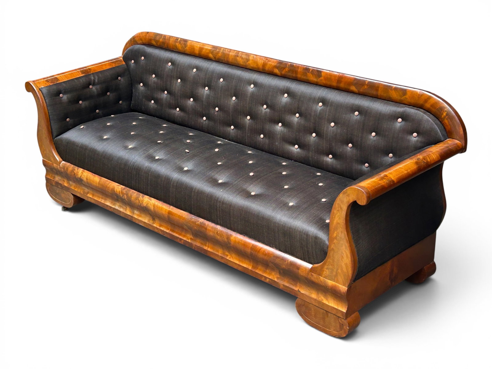 Antique Empire Sofa.: This antique Empire sofa has a flame mahogany frame, button tufted dark upholstery, curved arms, and curved block-style legs. The back panel is missing. There are some scratches, indentations, and