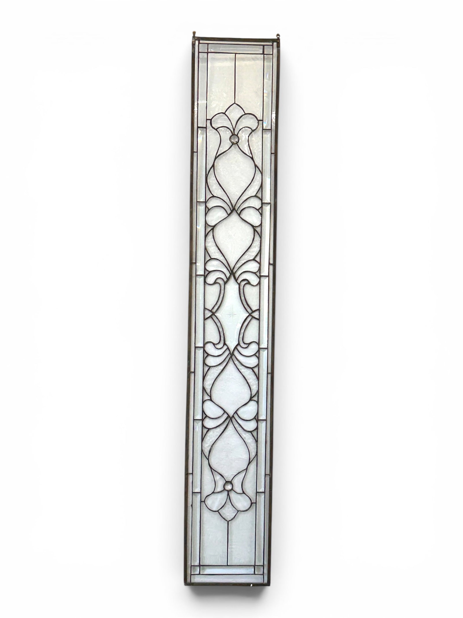 Bevelled Glass WIndow Panel.: This bevelled glass panel has an etched design, along with geometric patterns and floral leaded details. It has a pair of hooks on the top. One side of the frame is a little loose, and there are some