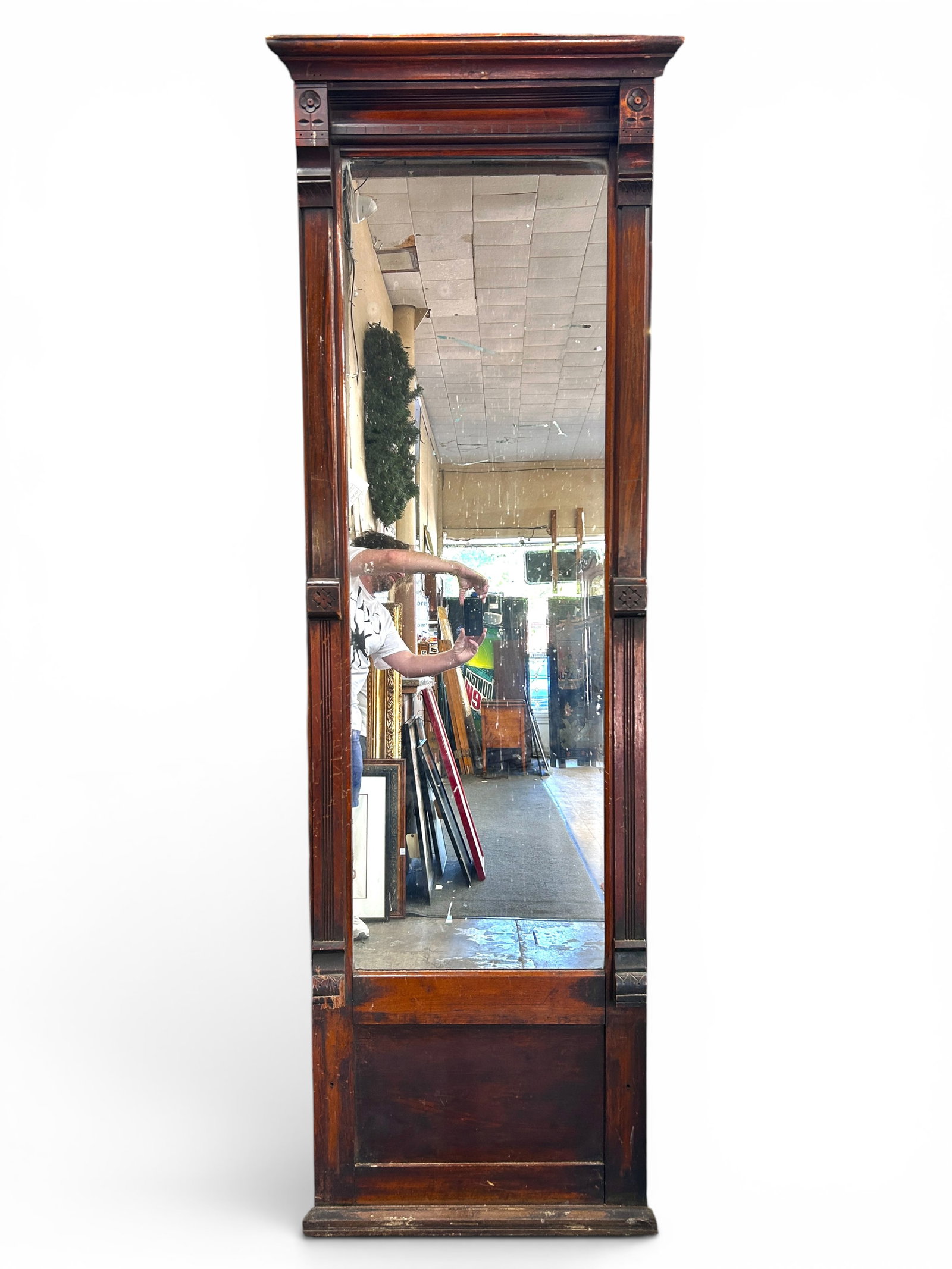 Victorian Eastlake Pier Mirror.: This walnut mirror has carved sides, a crest, and a paneled base. It is missing the molding on the top sides, and the mirror has desilvering. There are scratches and indentations. It measures 25"