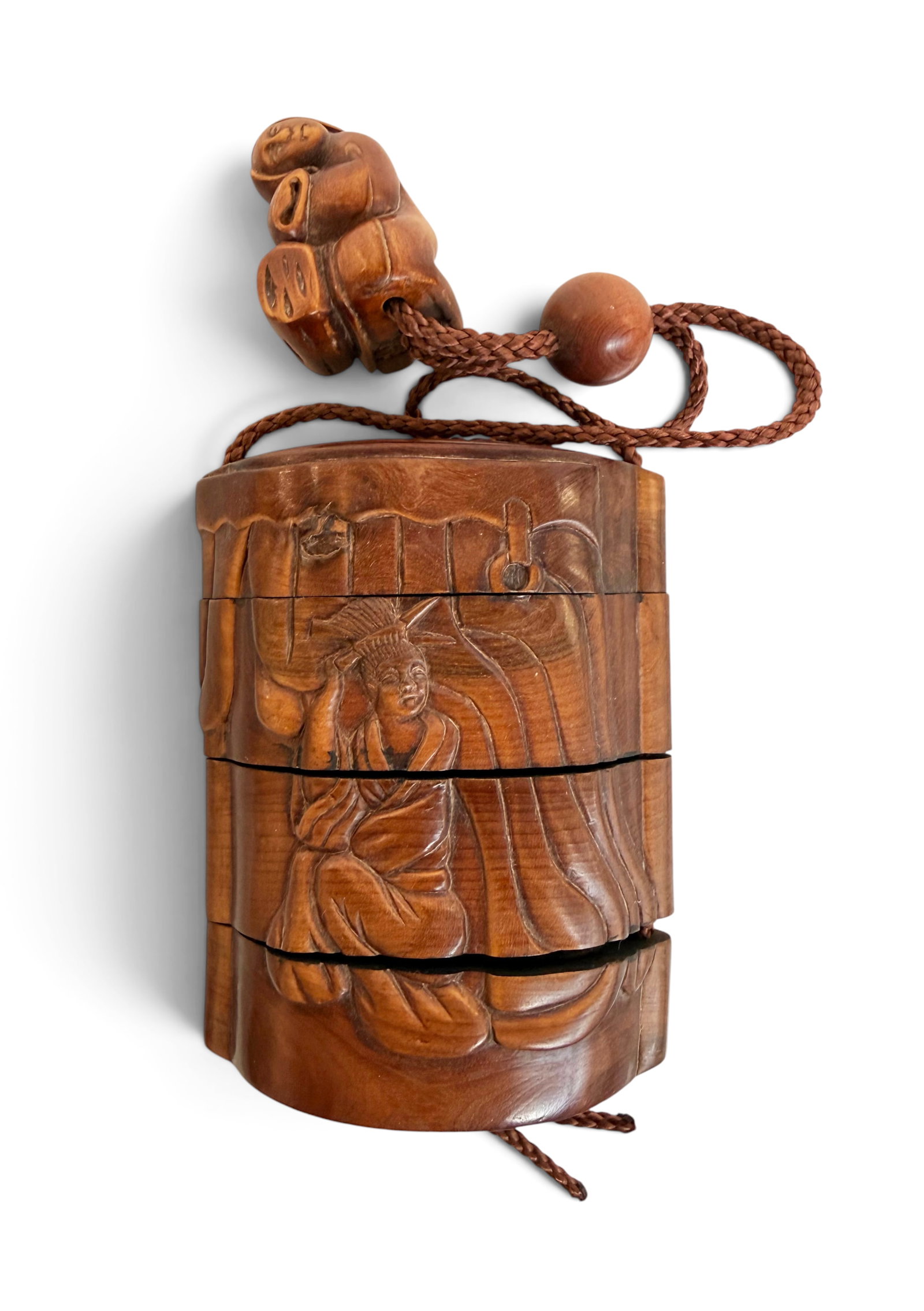 Carved Wood Japanese Inro, Geisha Figure.: The inro depicts a geisha figure in front of a curtain, and on the other side is a carving of a curtain and a stand. It comes in four sections. This piece also has a small carved wood small figure of 