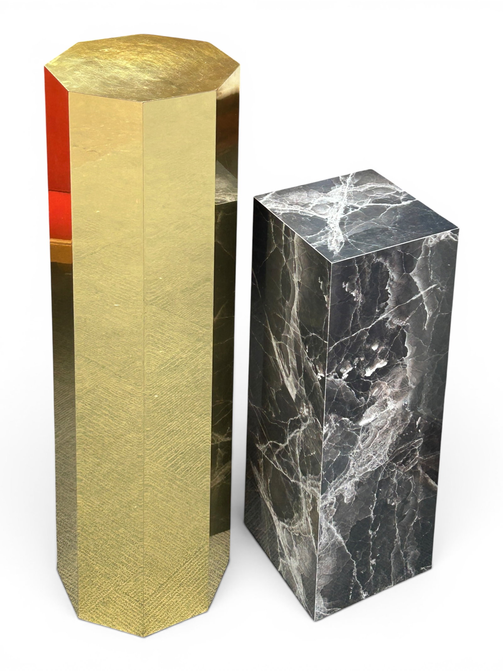 Lot of 2 Pedestals - Brass Octagonal & Faux Marble: The lot contains 2 pedestals or stands. There is an octagonal piece with brass veneer, which measures 42" tall and 12" in diameter. Next, there is a rectangular piece with faux black and gray marble
