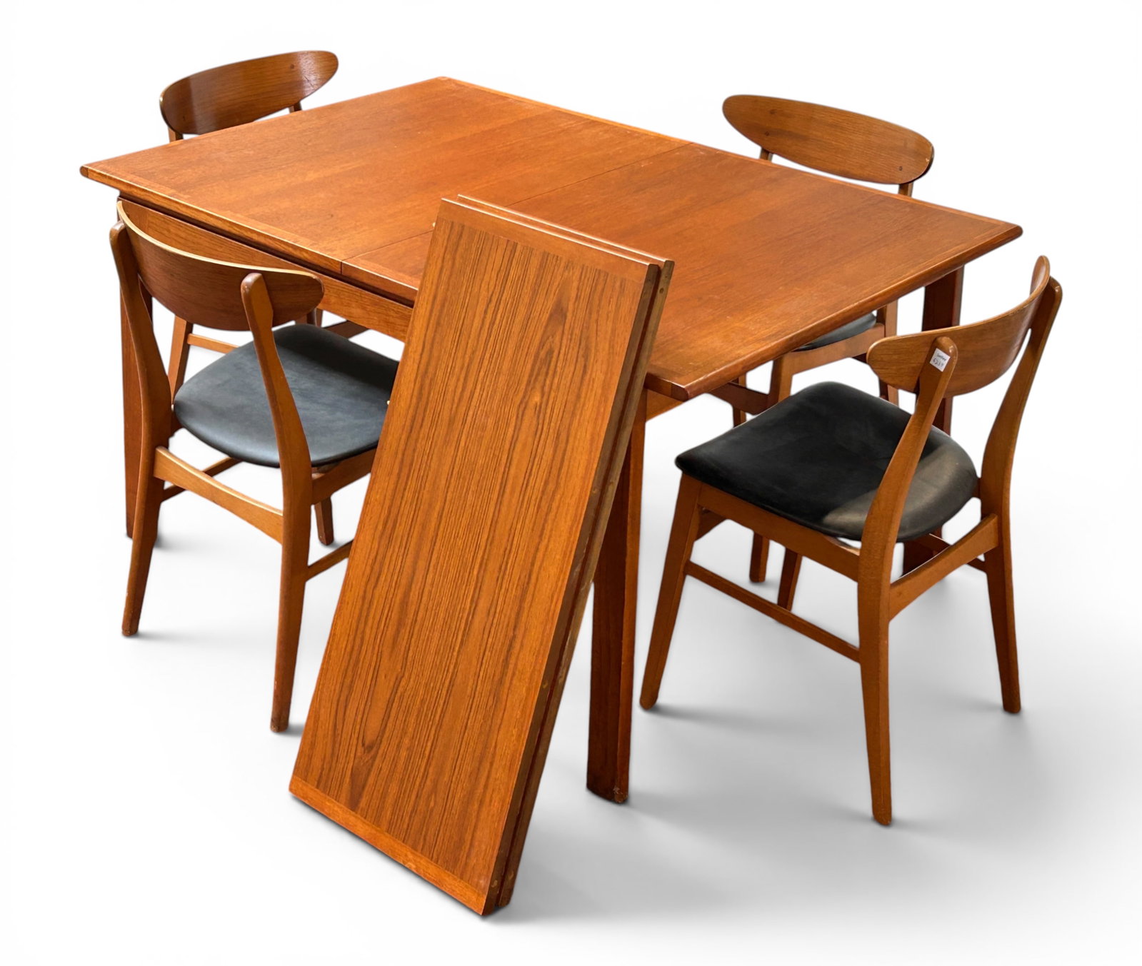 MCM Danish Teak Dining Table W/ Leaves & 4 Chairs.: The unbranded mid-century modern dining set comes with 4 chairs with black vinyl upholstered chairs. The table measures 28 1/4" tall, 55 1/4" long, and 36 1/8" wide (without the leaves). The 2 extra
