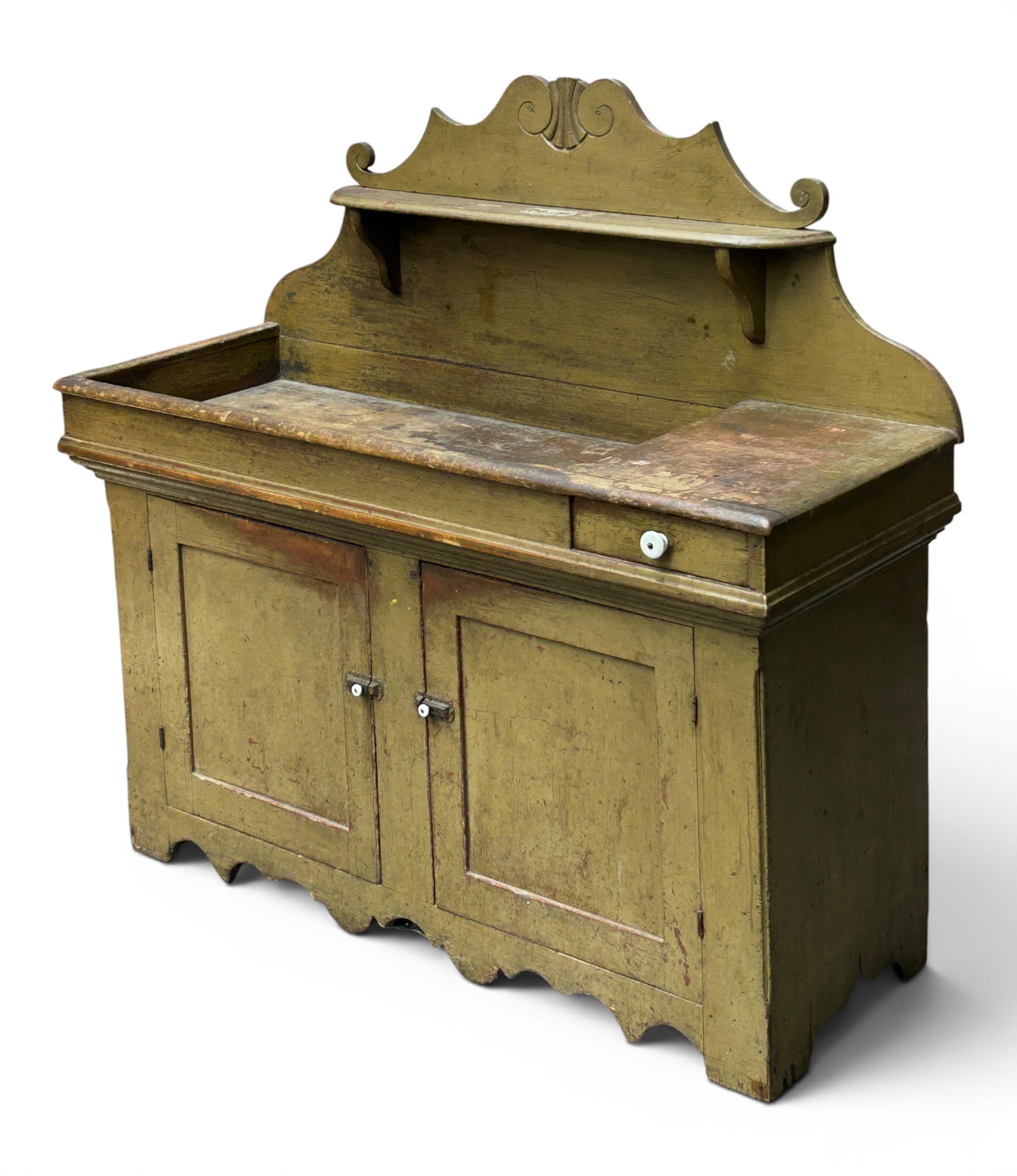 Antique Rustic Painted Dry Sink w/ Carvings.: The large dry sink has an upper shelf with a carved backsplash, one drawer with a porcelain knob, two doors with one shelf inside, and a carved apron. The doors have cast iron latches with porcelain