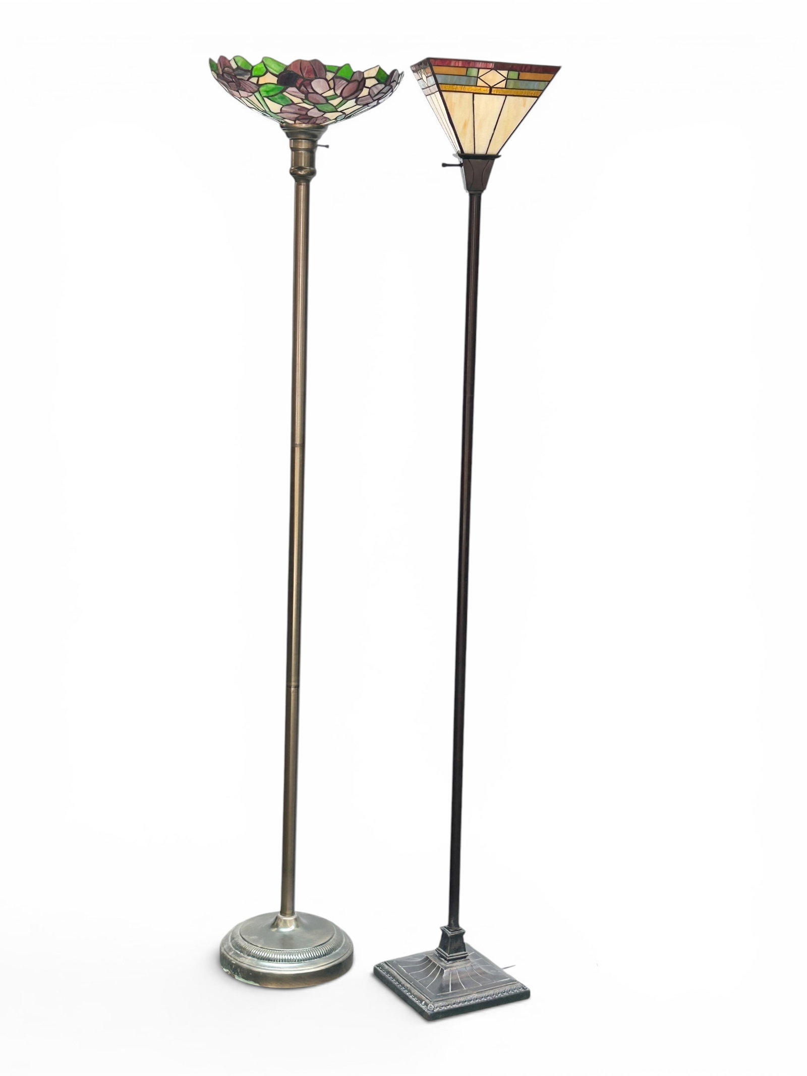 Two Modern Stained Glass Floor Torchiere Lamps: The lot contains 2 floor lamps. One has a brushed metal base and a floral shade with purple flowers and green leaves. The next piece has a prairie style geometric shade with various colors and a
