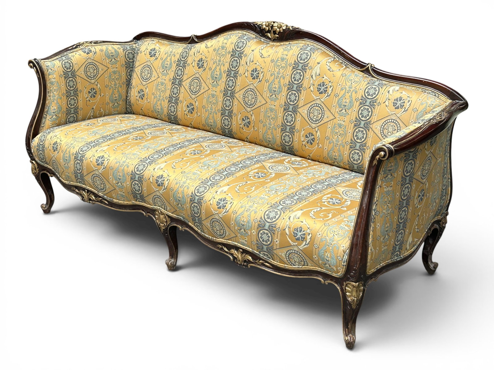 French Carved Sofa w/ Gilt & Antique Upholstery.: The antique sofa has flower, scroll, and fan carvings on the arms, apron, back, and cabriole scrolled legs. The antique upholstery has a gold-tone background with various shades of blue embroidery,