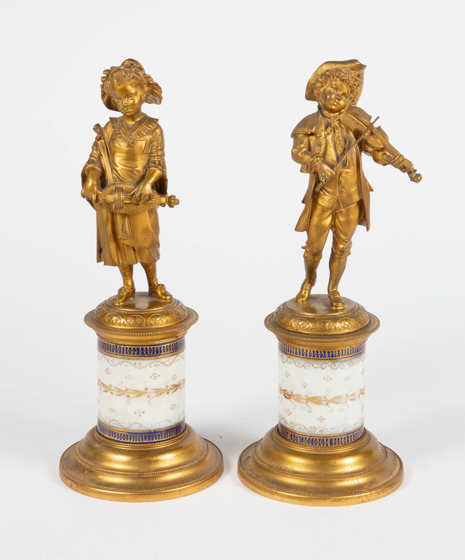 12" Bronze Pair of Young Musician Garnitures.: One is a male violinist, the other is a female lute player. There are some scratches and signs of tarnish, but overall, the lot looks to be in good condition. Each piece measures approximately 5" x