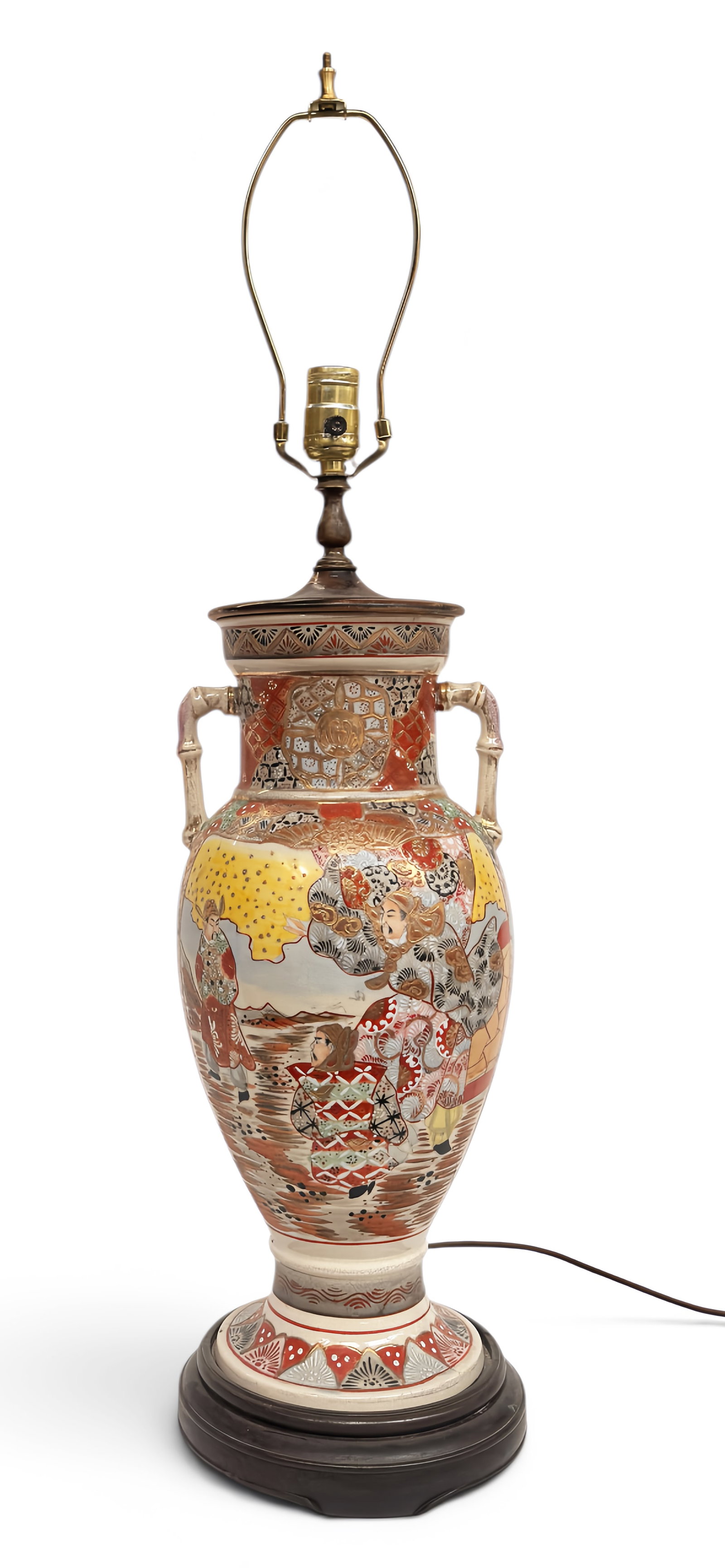 Japanese Satsuma Vase Lamp.: The lamp is composed of a Satsuma vase on a wooden stand. The vase features figural scenes with heavily gilded ornate decorations. From the top of the shade holding hardware to the bottom of the woode