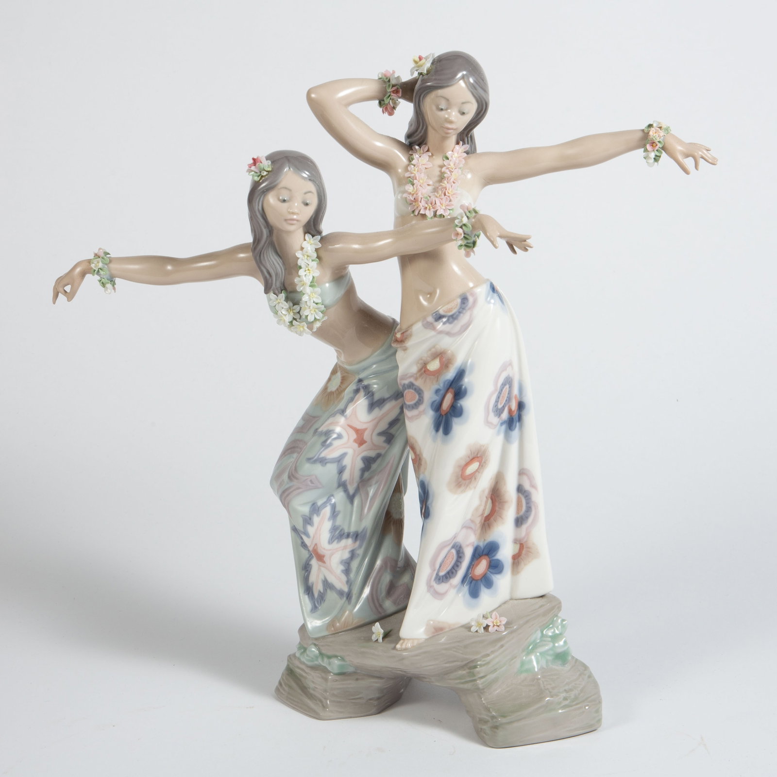 Lladro Tahitian Dancers Figurine.: This figurine depicts two dancing women with flowers and long skirts. There are some chipped petals, and they both have had some repairs done to their fingers. The figure measures 12 1/2" x 3 1/2" x 1