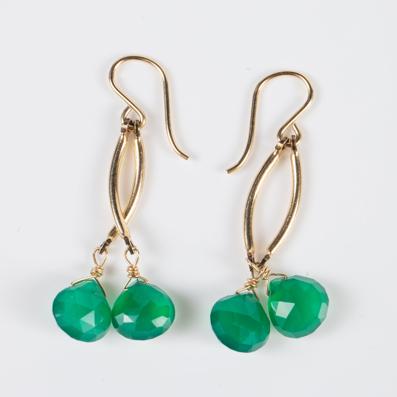 Pr. of 10K Yellow Gold & Green Stone Earrings.: The unmarked earrings tested electronically for 10K gold. They feature 2 curved dangling posts each with a multifaceted teardrop cut green stone. They measure 1 1/4" long (not including the hook). The
