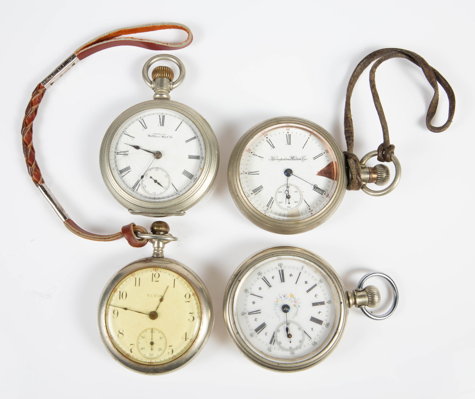 4 Open Face Pocket Watches - Waltham, Etc.: The lot contains 4 vintage pocketwatches. There is an Elgin piece with a crystal back. It is 17 jewels, and is marked G.M. Wheeler / Elgin, Ill. U.S.A. on the movement. The next piece, which has color