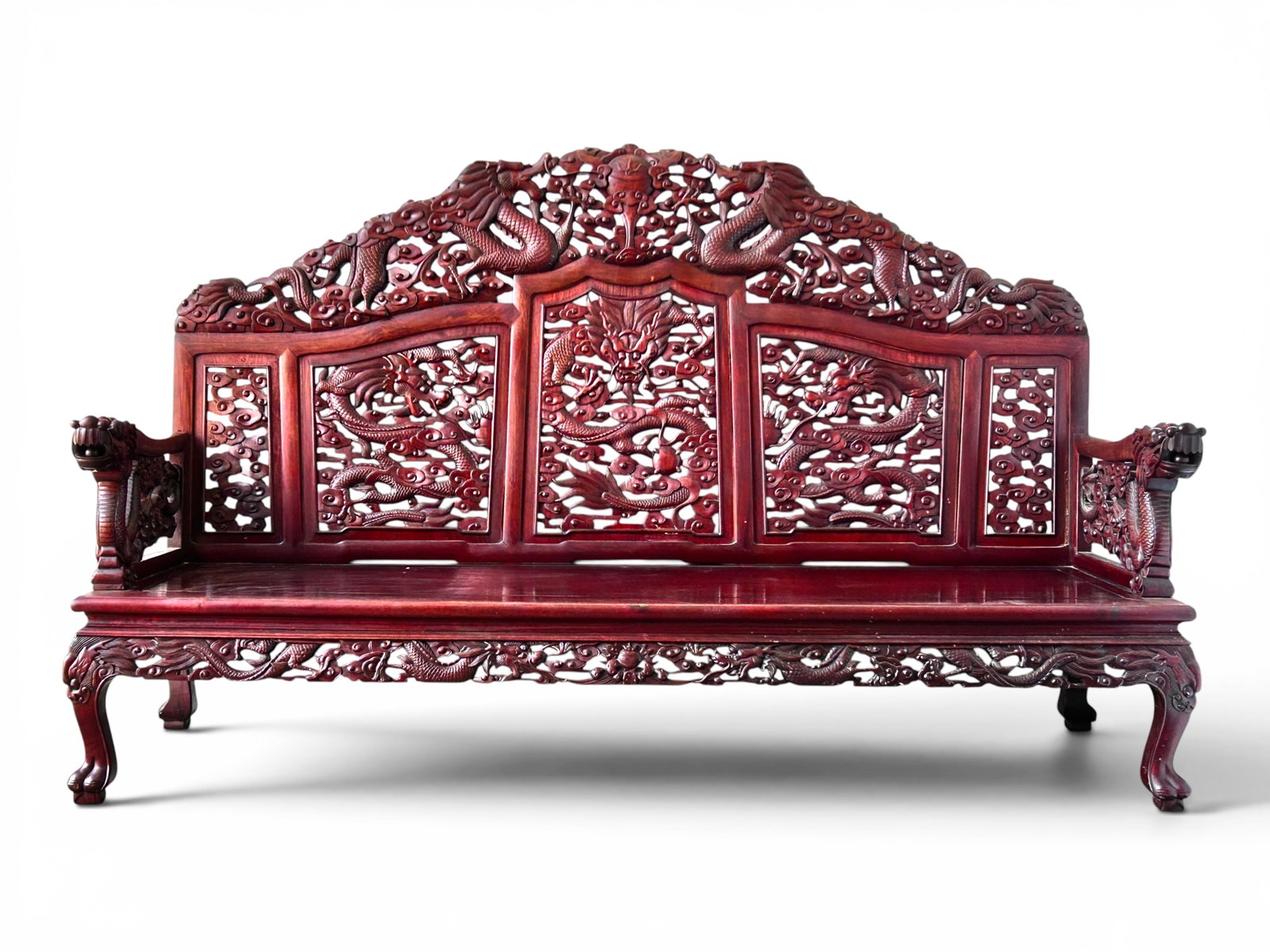 Chinese Heavily Carved Redwood Bench, Dragons.: The bench has pierced carvings of dragons and clouds on the back, arms, and apron, and 4 curved paw feet legs. The dragons on the arms have free rolling wooden balls in their mouths. It measures 45