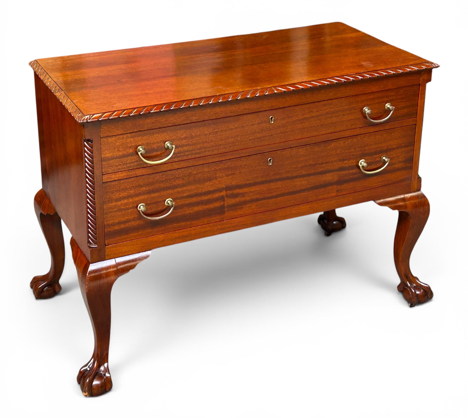 Chippendale Style Drawer Chest w/ Ball & Claw Feet: The mahogany drawered chest has a carved top border, twist column-style front corner columns, and 4 carved ball and claw feet on casters. The piece measures 31 1/2" tall, 41 1/2" wide, and 20" deep.