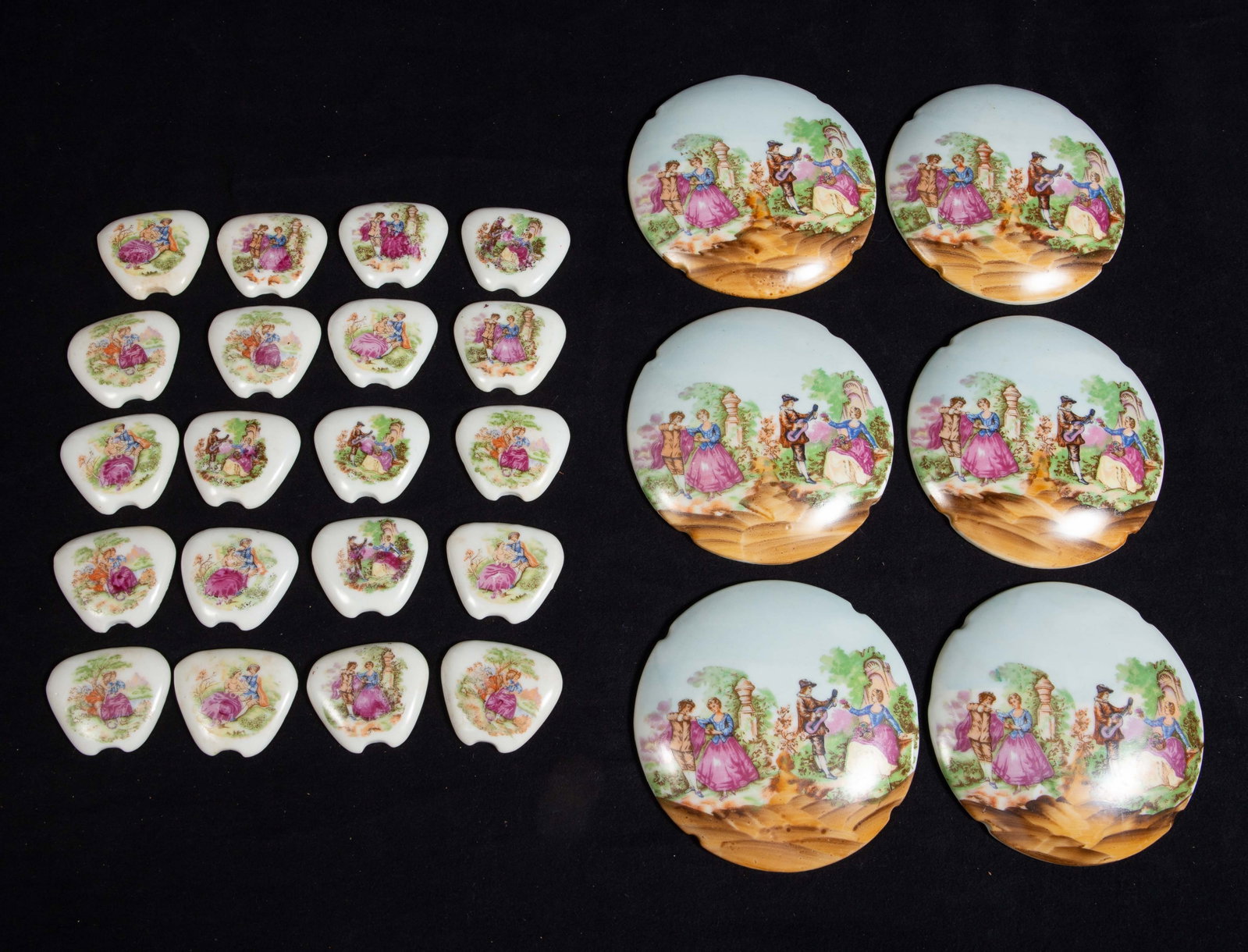 Lot Japan Export Porcelain Plaques Courting Scenes: The lot contains 6 round wall hanging plaques and 20 small triangular panels with curved notches on the narrow end. The items feature Limoges style European courting scenes, and all the items are stam