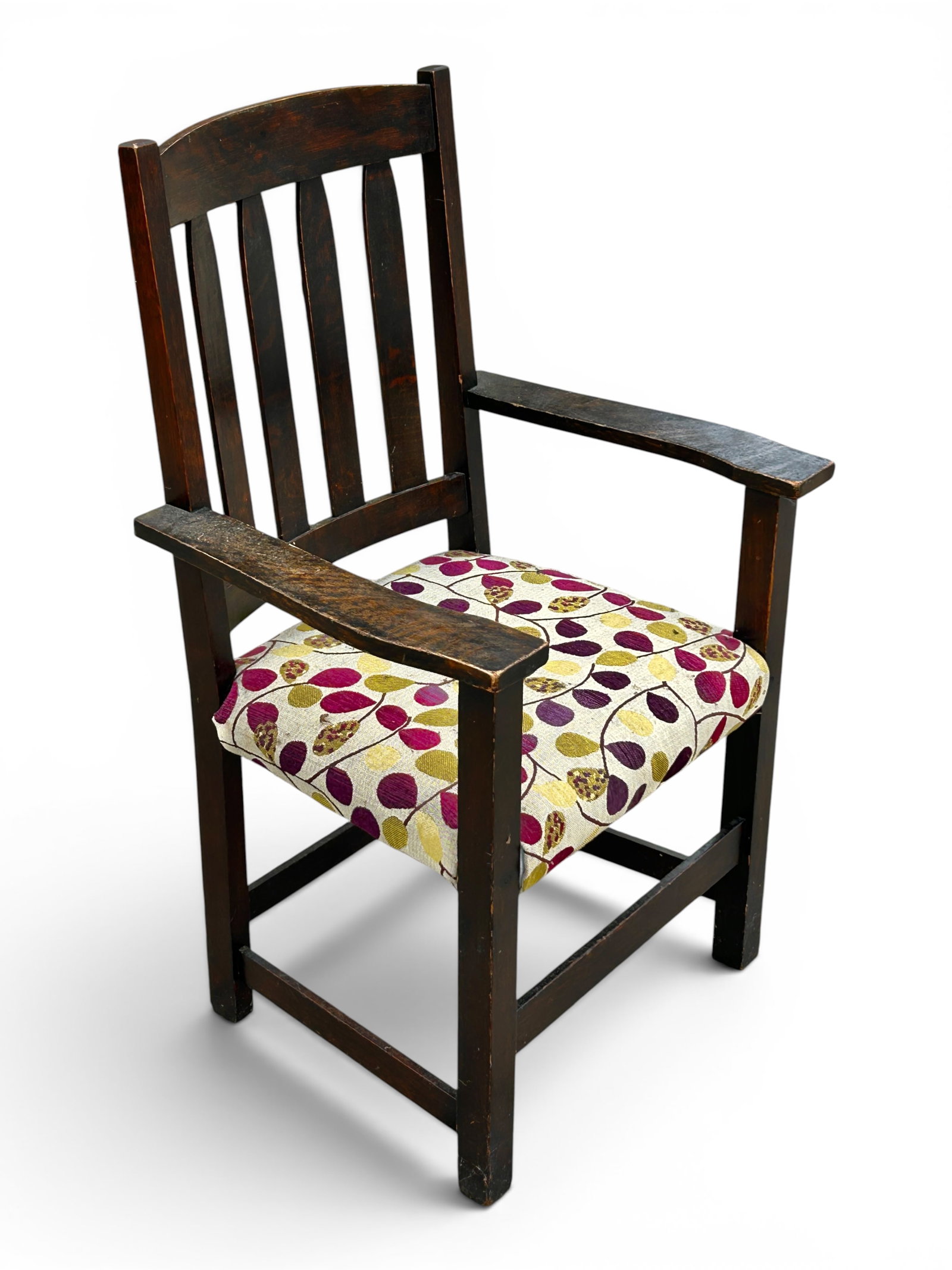 Signed Limbert Oak Armchair.: The chair has a slat back, wide armrests, straight legs, and stretchers. The seat has floral upholstery. There are some scratches, indentations, and loss of varnish. It measures 25" wide, 18" deep,