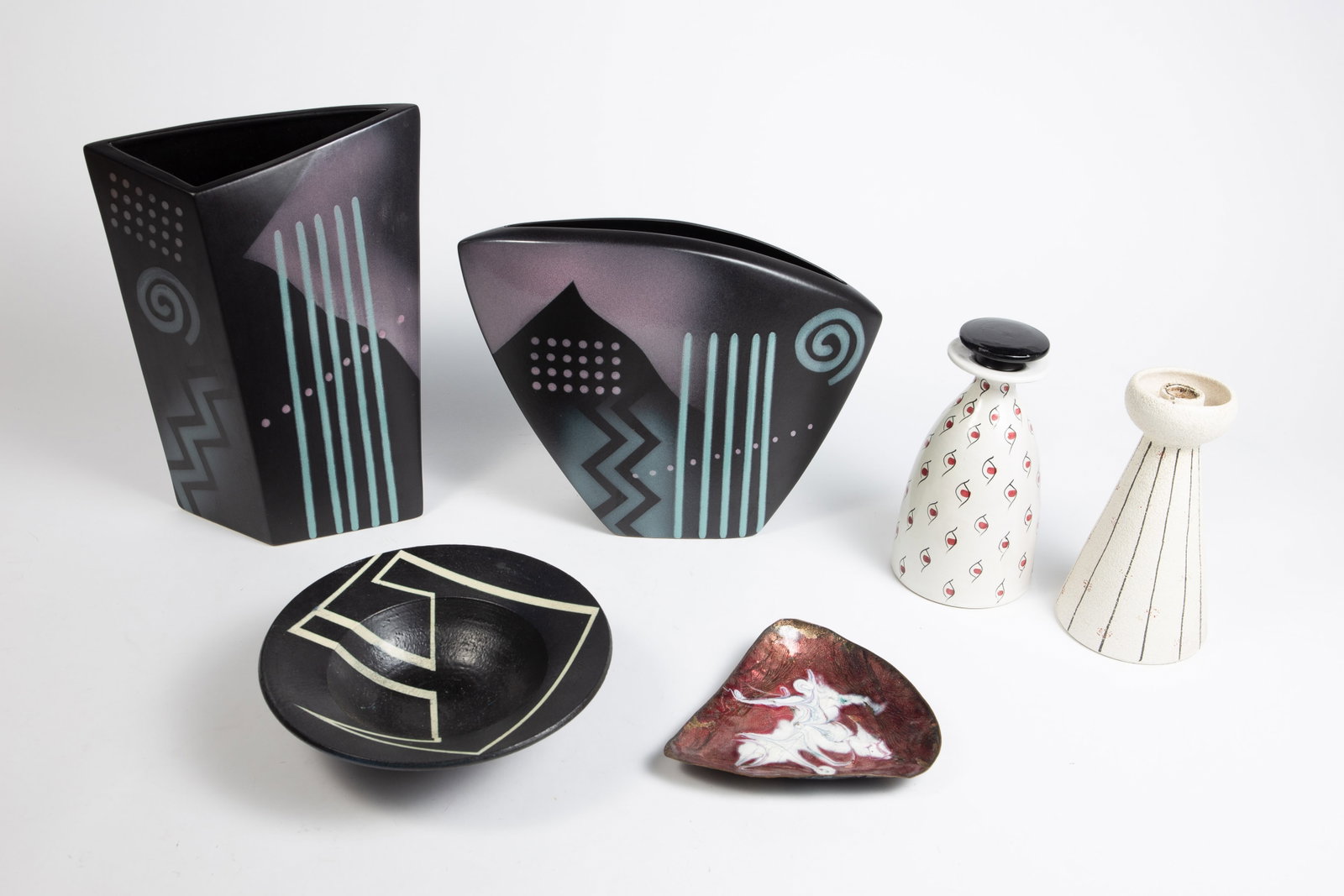 Lot: John Bergen, Aldo Londi for Bitossi, etc.: This lot includes an Aldo Londi for Bitossi candlestick (some nicks and paint loss), an Aldo Londi for Bitossi vase with stopper (some nicks and small cracks), two John Bergen postmodern vases, an ena
