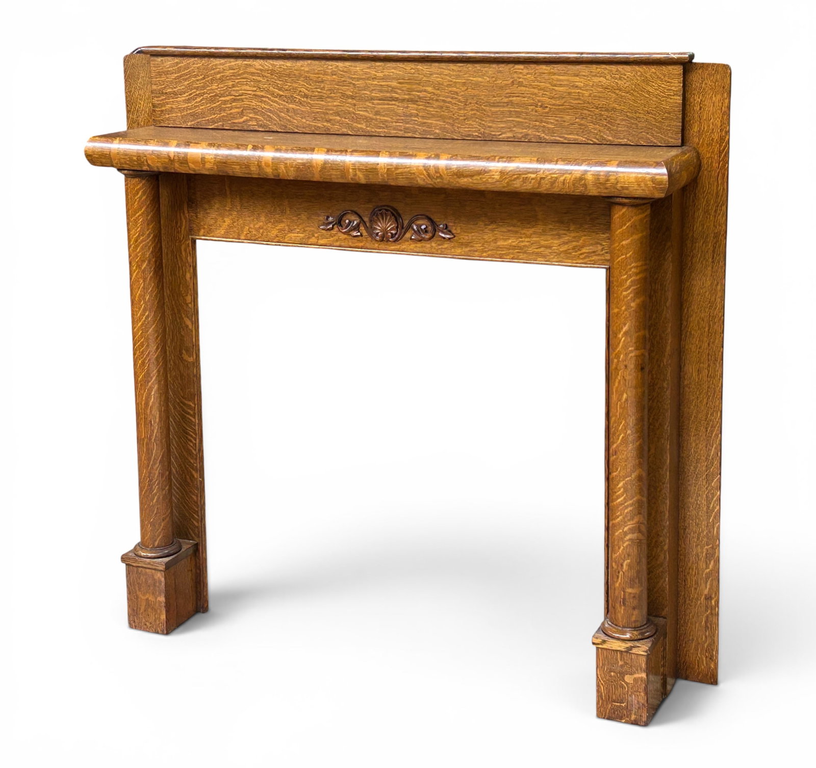 Antique Quartersawn Oak Fireplace Mantel.: The fireplace mantle and surround features a backsplash, rounded edges, and scroll, foliage, and fan or sea shell carvings on the section above the fireplace. The piece measures 55 3/4" tall, 60 1/4"