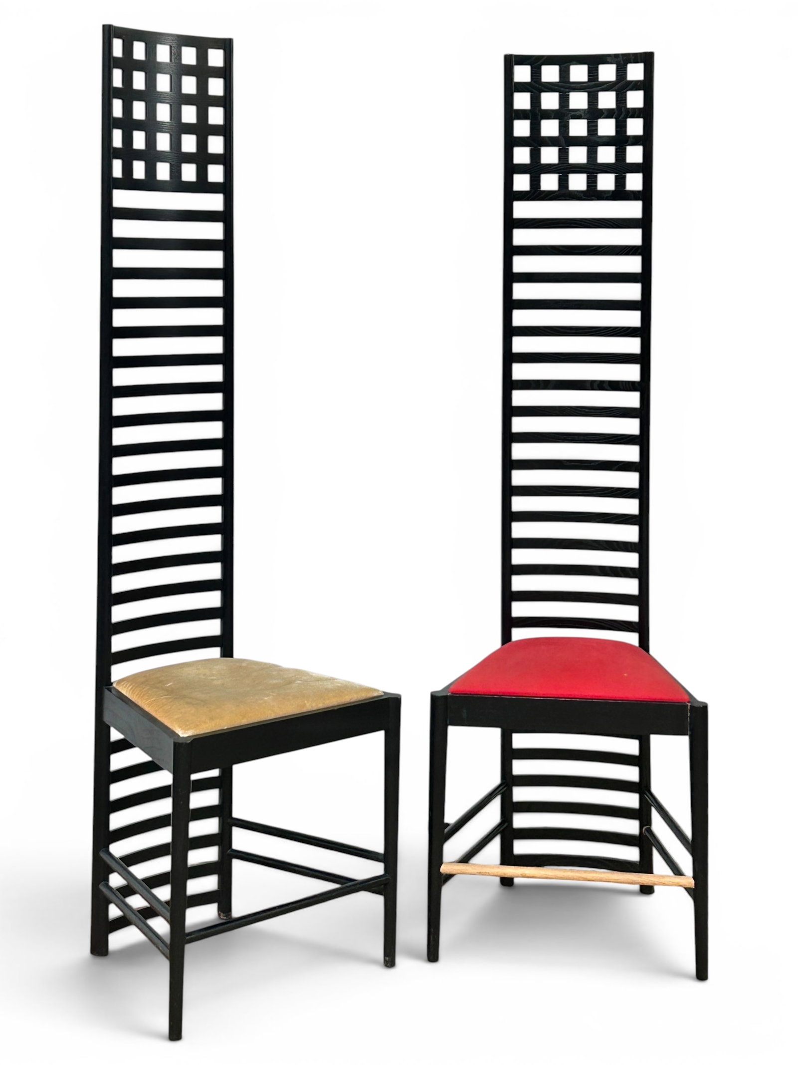 Pair of Charles Rennie Mackintosh Cassina Chairs.: The chairs have the original stamp and number 1154. Both feature ebonized frames with tall backrests and a lattice design. The seats are padded. One of the chairs has a front stretcher that is not