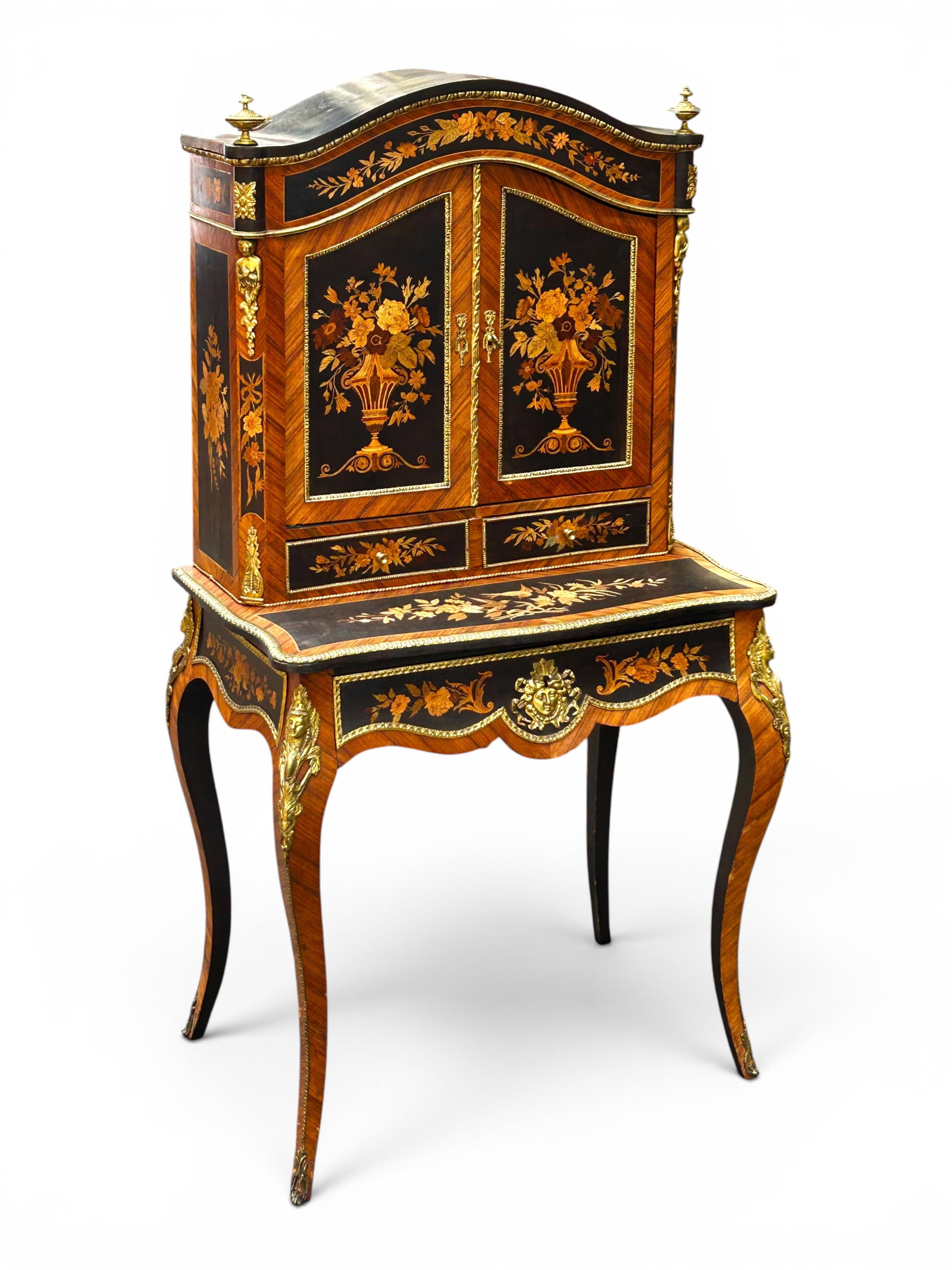 Ornate French Napoleon III Desk, Marquetry & Brass: The antique bonheur du jour desk features 13 sections with inlaid marquetry scenes and ornate brass or gilded trim and decorations, and 7 figural busts. The marquetry depicts flowers, a pair of