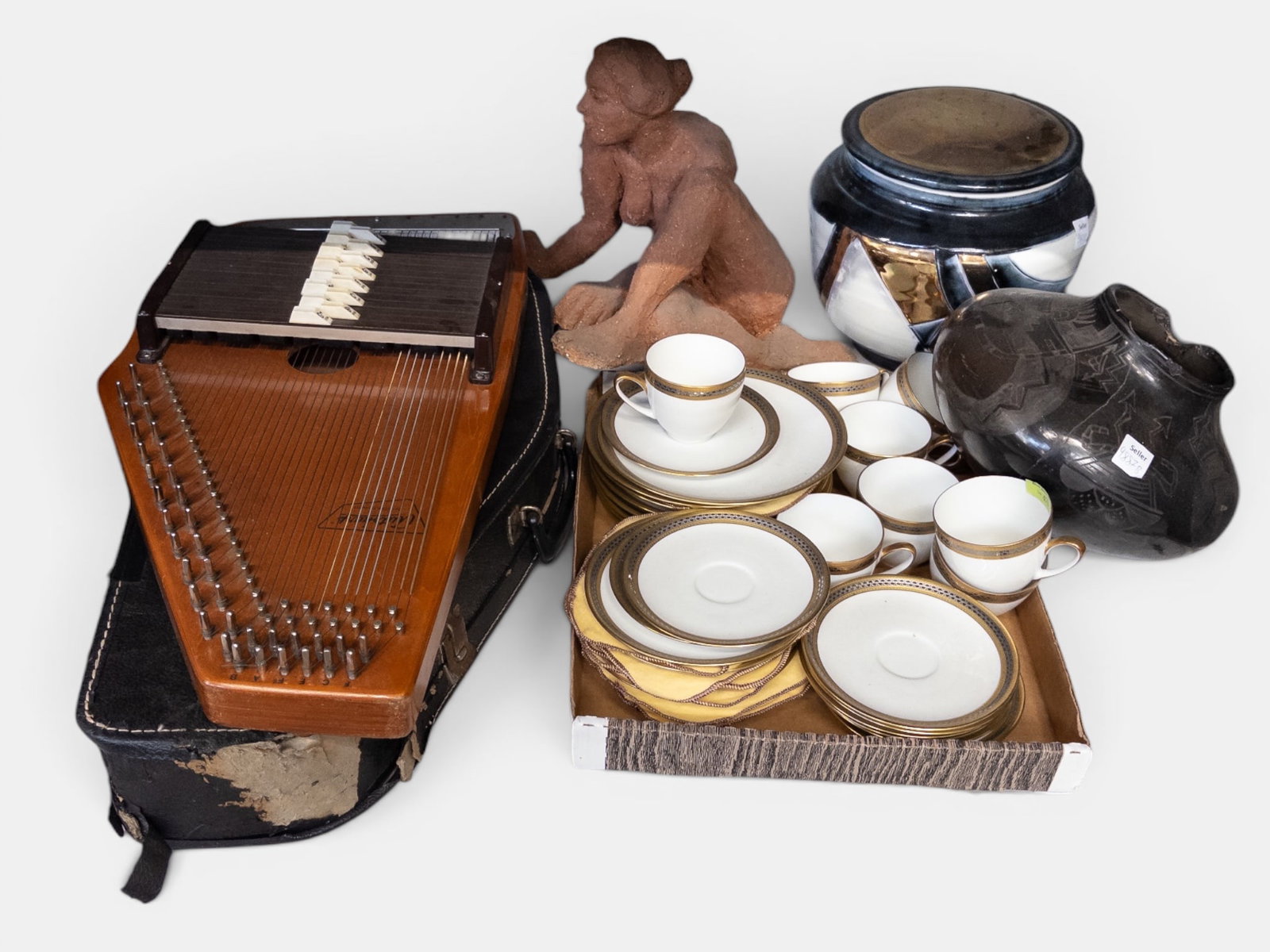 Lot: Hutchenreuther China, Nude Sculpture, etc.: The clay sculpture appears to be unsigned. The Hutschenreuther set includes teacups, saucers, and dessert plates. The lot also includes an American Indian vase (chipped and cracked), a large pottery j