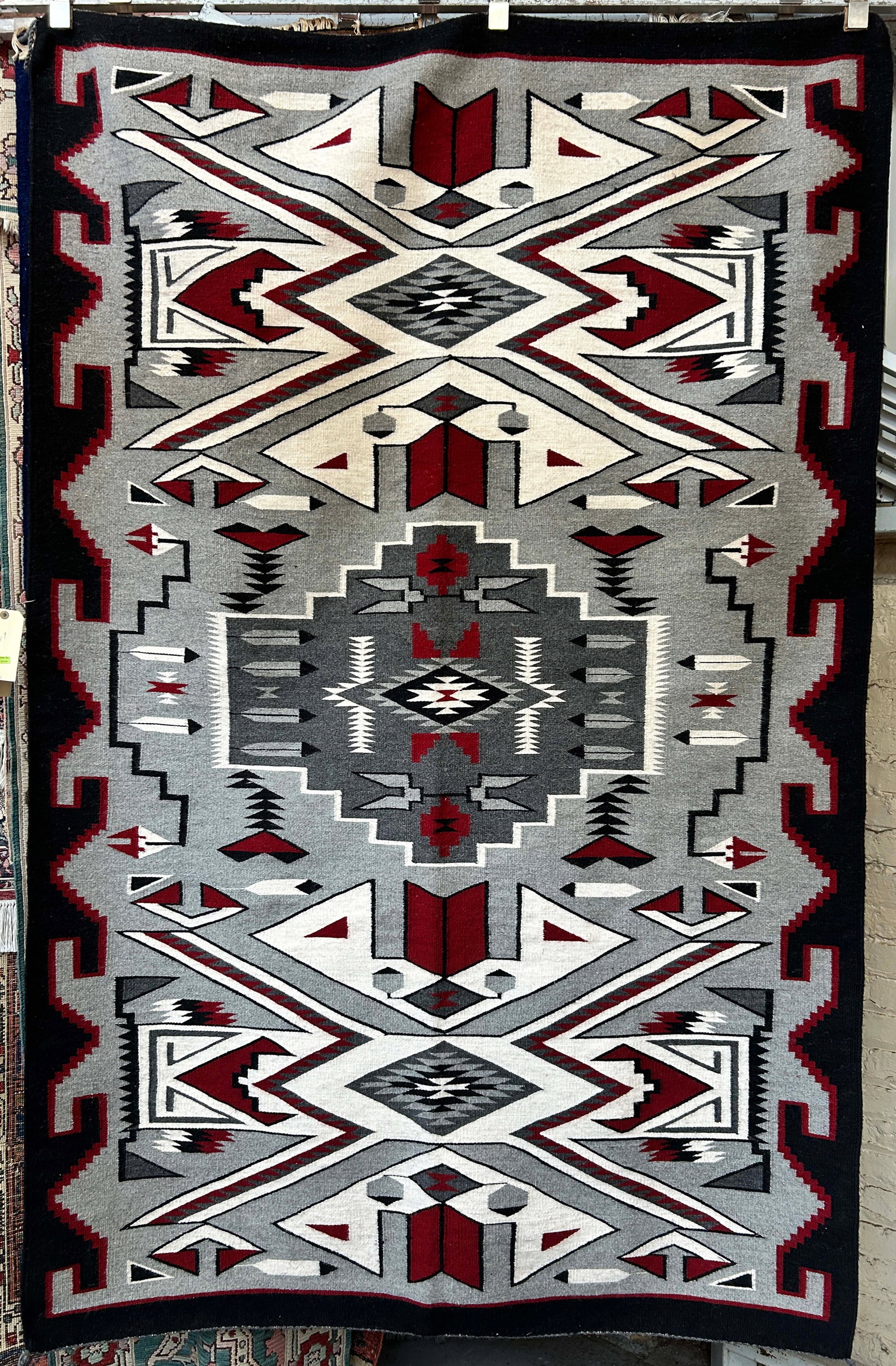 4' 9" x 7' 4" Navajo Eye Dazzler Rug.: The rug looks to be in the newer side. It is in excellent condition, with a bedazzling pattern. In-House Shipping is available for this rug. Please see our website for our in-house shipping procedures