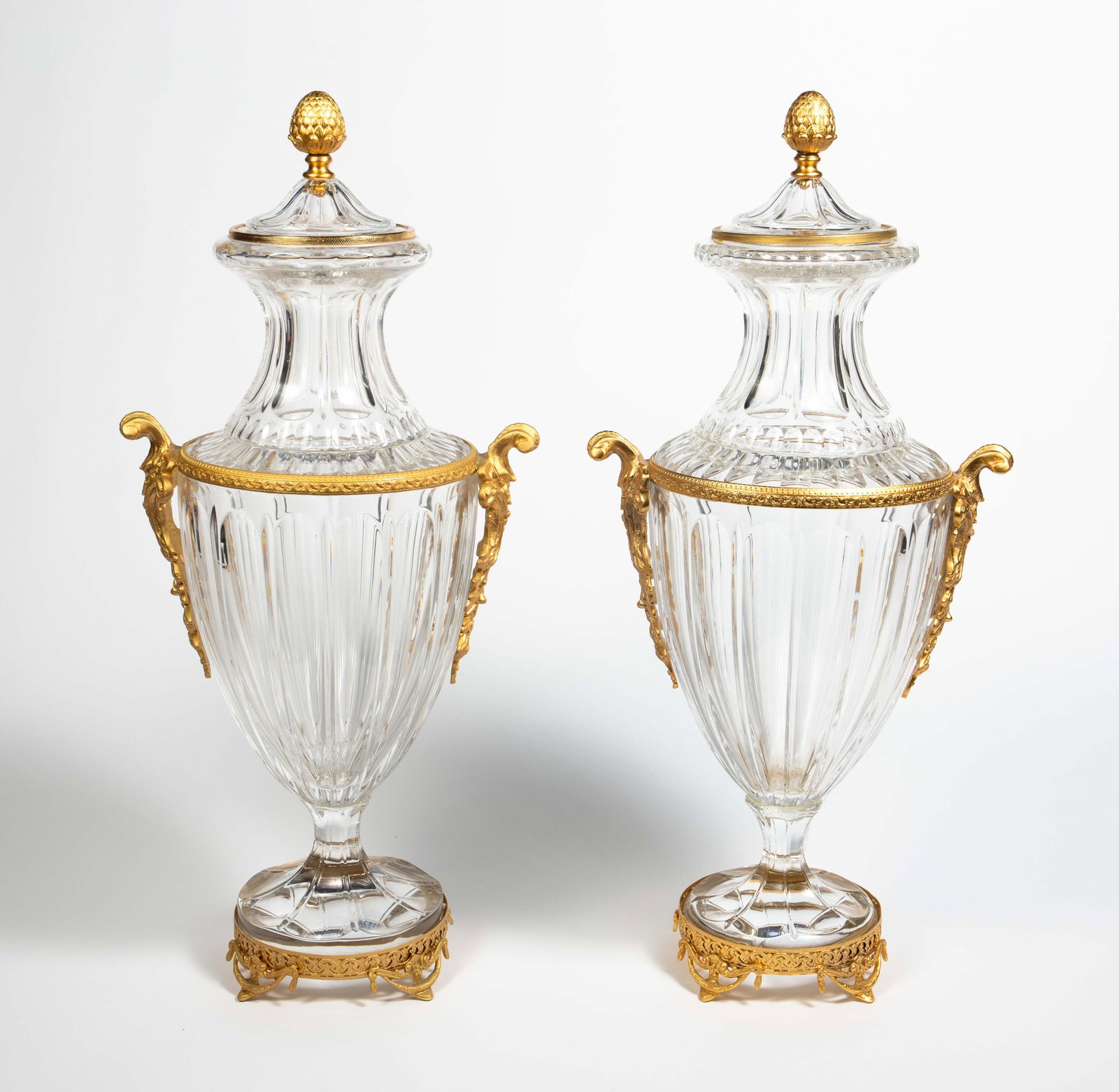 28" Neoclassical Baccarat Style Crystal Urns.: They look to be in overall good condition. One of them has more noticeable scratches, and some residue from adhesive on a gilded band. Each one measures approximately 13" x 10 1/2" x 28". They are