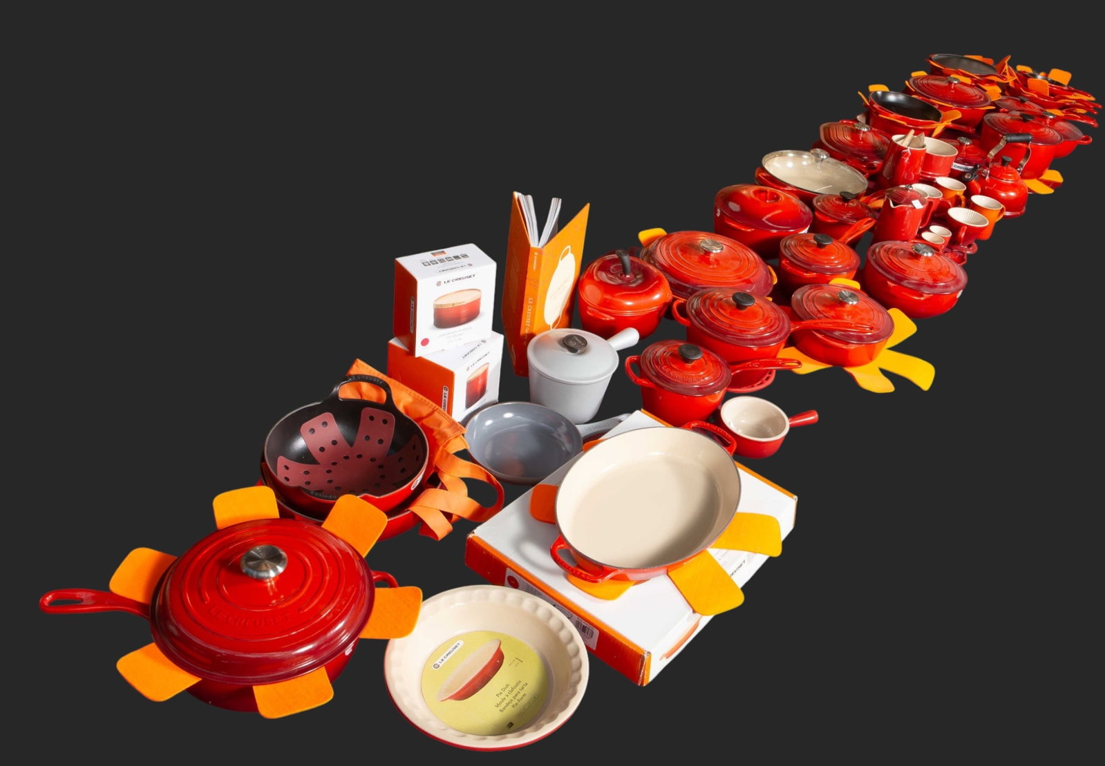 Massive Lot of Like-New Red Le Creuset Cookware.: This lot contains over 50 individual items, including cast iron and ceramic pieces. They look to be in overall great condition; a few pieces even come with the original boxes. The lot includes dutch o
