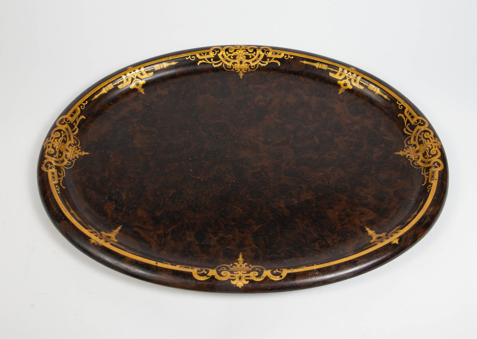 Jennens & Bettridge Oval Platter w/ Gold Designs.: This gold painted and lacquered signed tray has some craquelure and spots of paint loss, but looks to be in overall good condition. It measures 24 3/8" x 19 1/8". In-house shipping is available.
