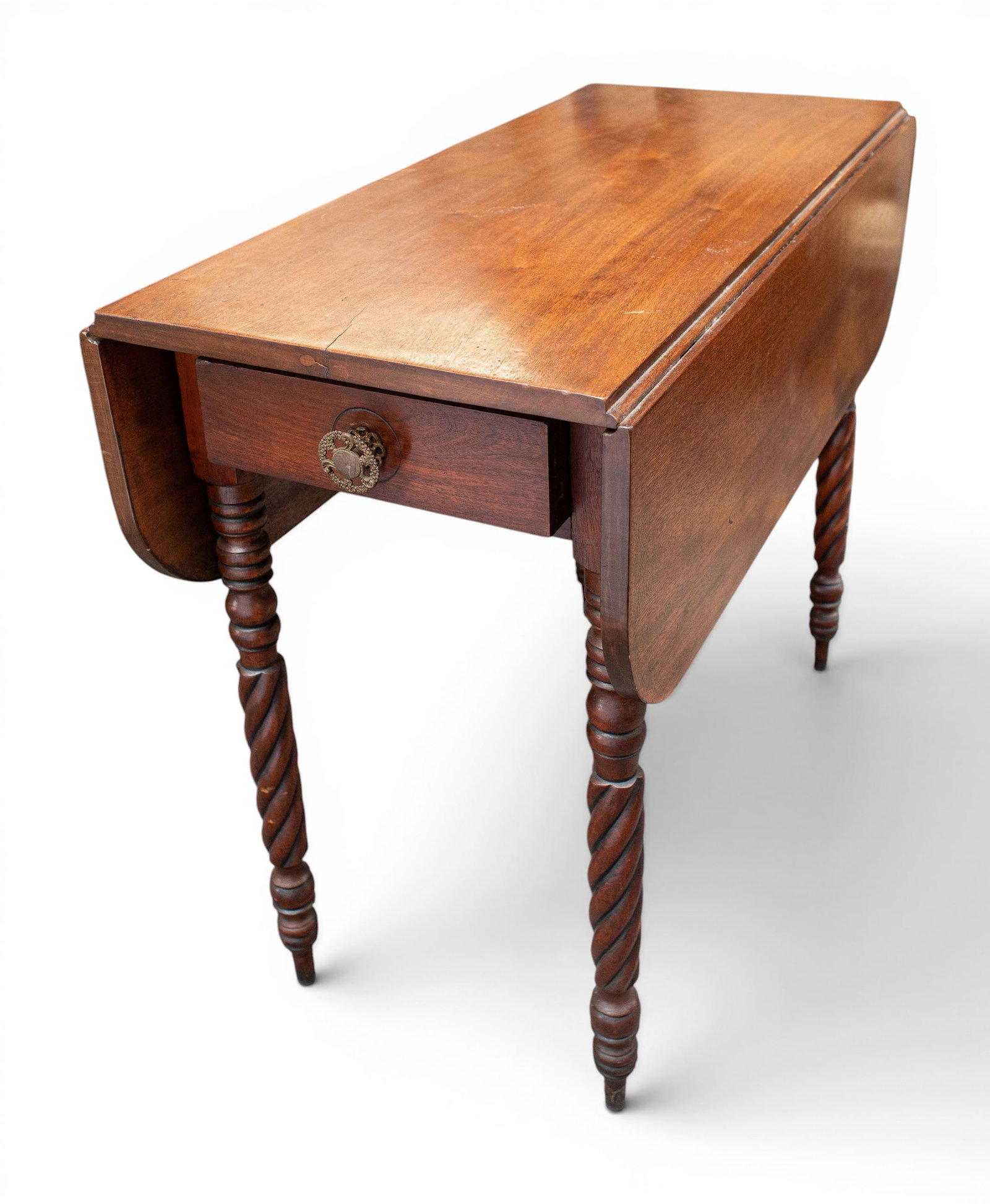 19th Century Carved Dropleaf Table.: The table has rope-carved legs and one drawer with a brass decorated pull or handle. There are some scratches and indentations, but overall, it is in good condition. The piece measures 36" wide, 15"