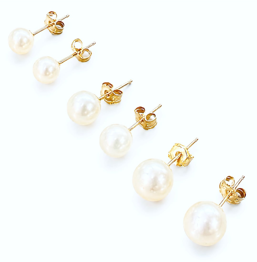 3 Pair 14K Yellow Gold Pearl Stud Earrings - IWI: The lot contains 3 pair of pearl stud earrings with 14K gold posts and backs. The posts and backs are marked 14K IWI for Imperial World Incorporated. The earrings have different sizes of pearls. The s