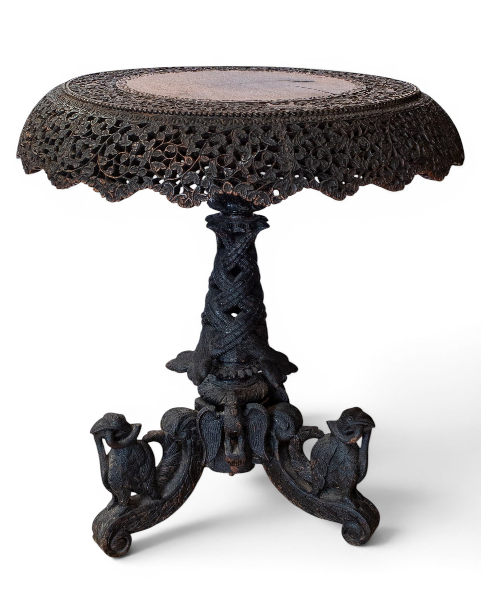 Anglo Indian Carved Flip Top Table.: This intricately carved table from India features filigree carvings, a beaded border, and a pedestal base with highly carved eagles. It is in good condition, with some wear. The piece measures 30" tal