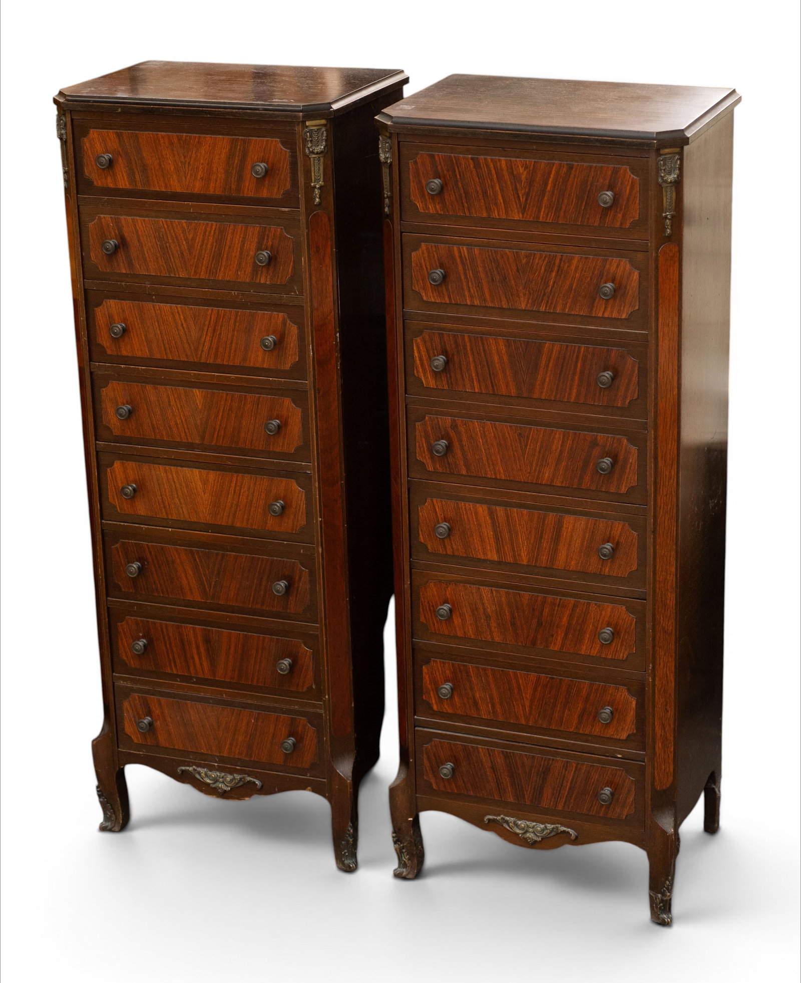 Pair of French Style Lingerie Chests.: These mahogany chests are by the Colonial Manufacturing Company. Each one has eight drawers with brass hardware and brass appliques. Both have minor damage to their tops. Otherwise, they are in good c