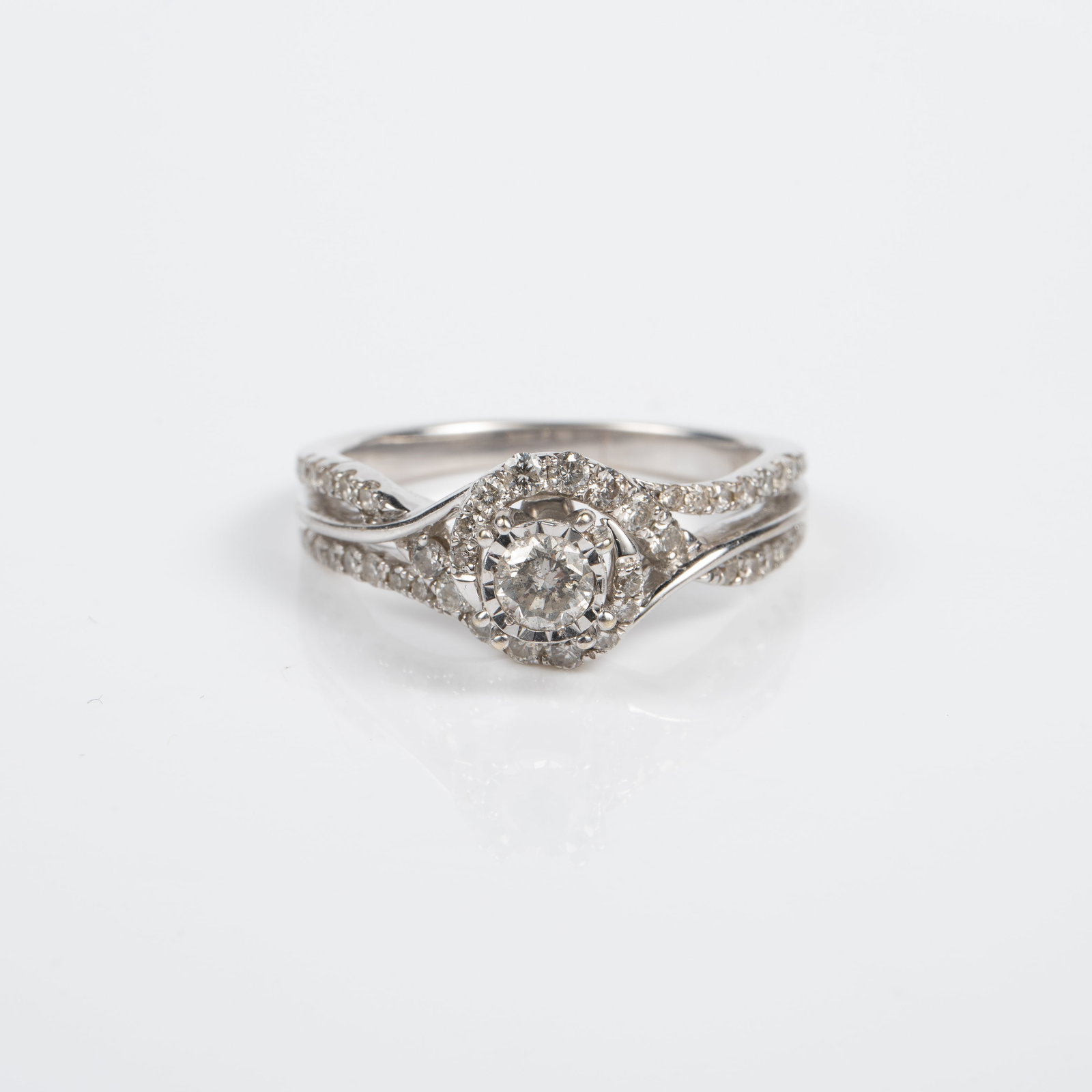 14K White Gold & Diamond Engagement Ring.: The ring is unmarked, but tested appropriately for 14K gold. It features a central 3mm diameter round brilliant diamond on a 5mm from top to bottom setting. The ring also has flanking rows of small ro