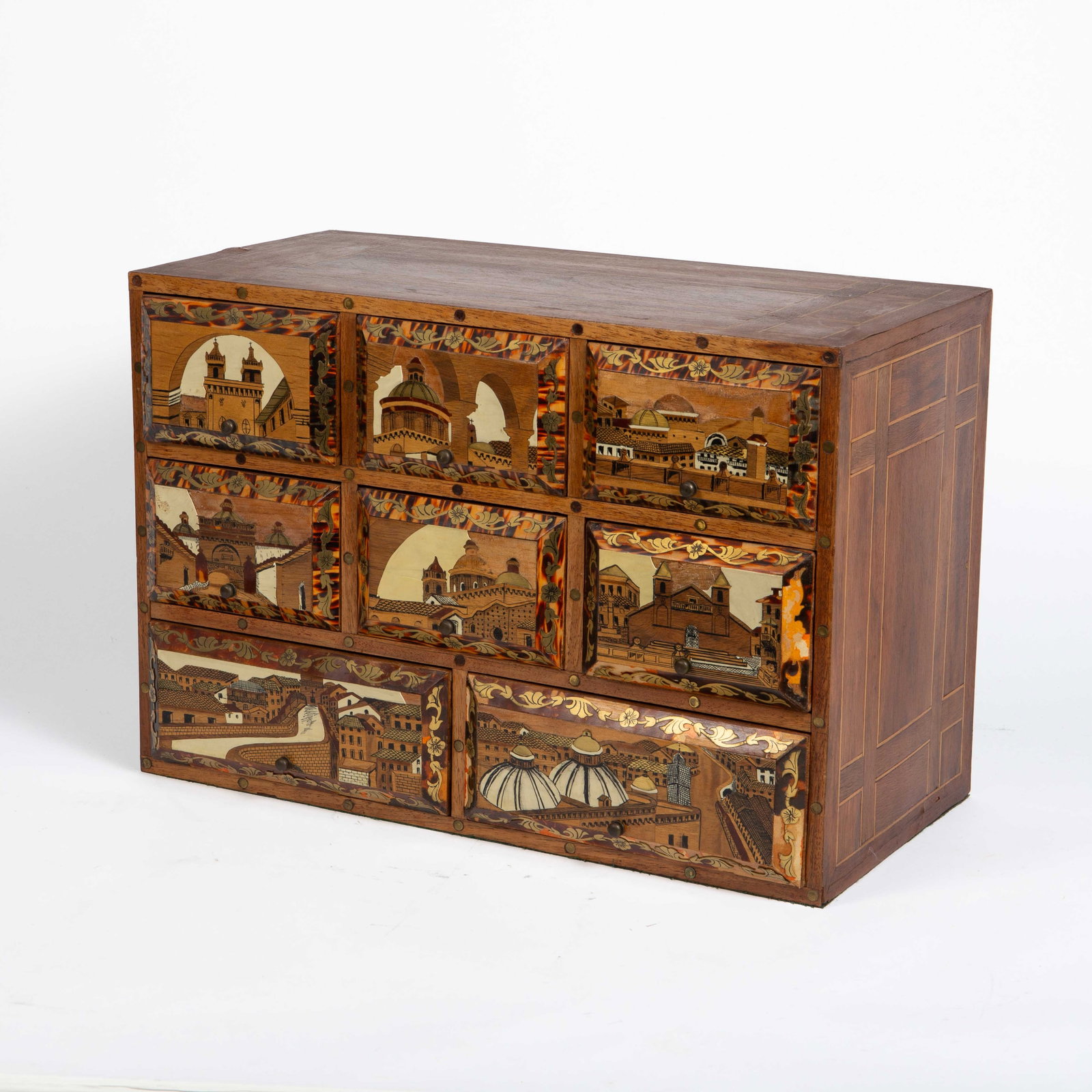 Augsberg Style Table Top Marquetry Drawer Chest: The 8-drawer collector's cabinet or jewelry chest features marquetry cityscape scenes on the drawers, and inlaid geometric decorations on the top and sides. The drawers have thick cushions inside them