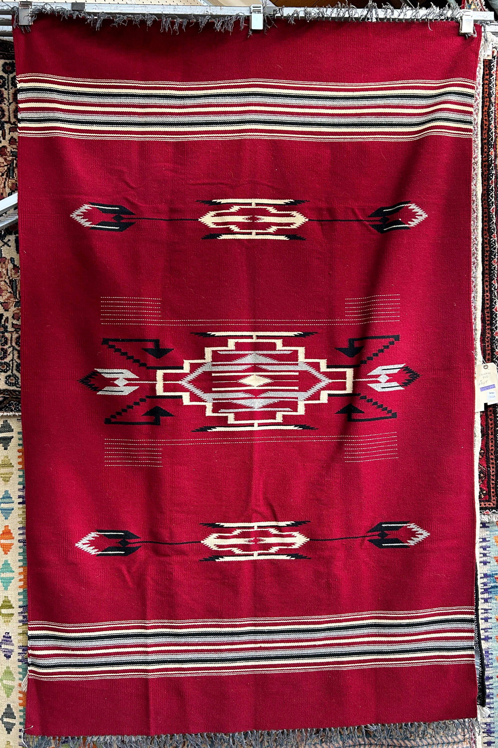 4' 5" x 6' 9" Red Chimayo Rug.: The rug looks to be in good condition. In house shipping is available for this rug. Please see our website for in house shipping procedures.
