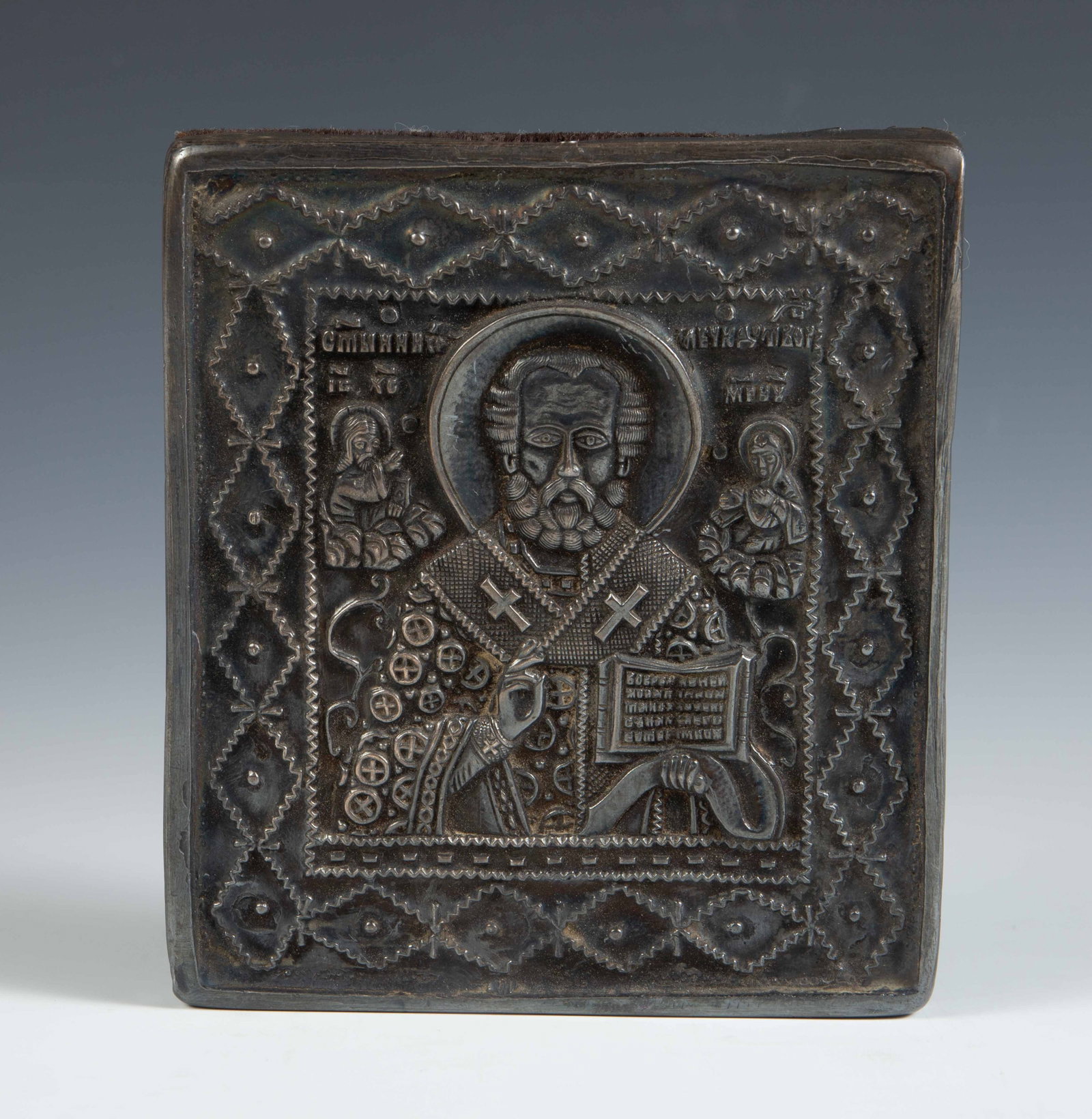 Russian Orthodox Silver Icon of Saint Nicholas.: This small hanging icon has a silver surface affixed to a velvet-covered block. Overall, it presents well. The dimensions are 4 1/4" x 3 3/4" x 7/8". In-house shipping is available. Please see our web