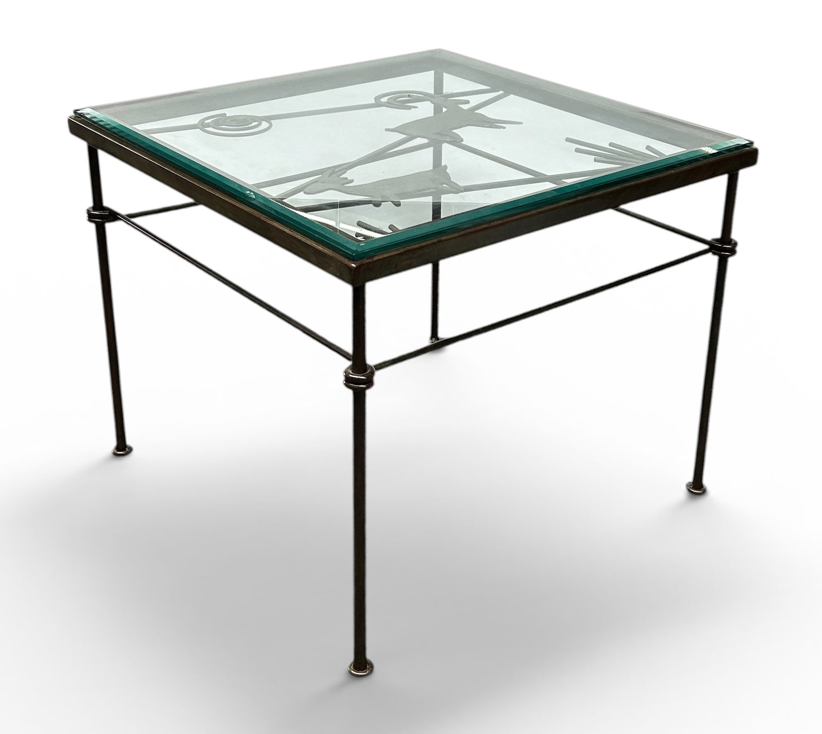 Giacometti Style Iron & Glass Coffee Table.: The wrought iron table and decorative elements under the beveled glass have a bronze finish. The beveled glass top is a few millimeters smaller than the base. The table measures 20 1/2" tall, 24 7/8"