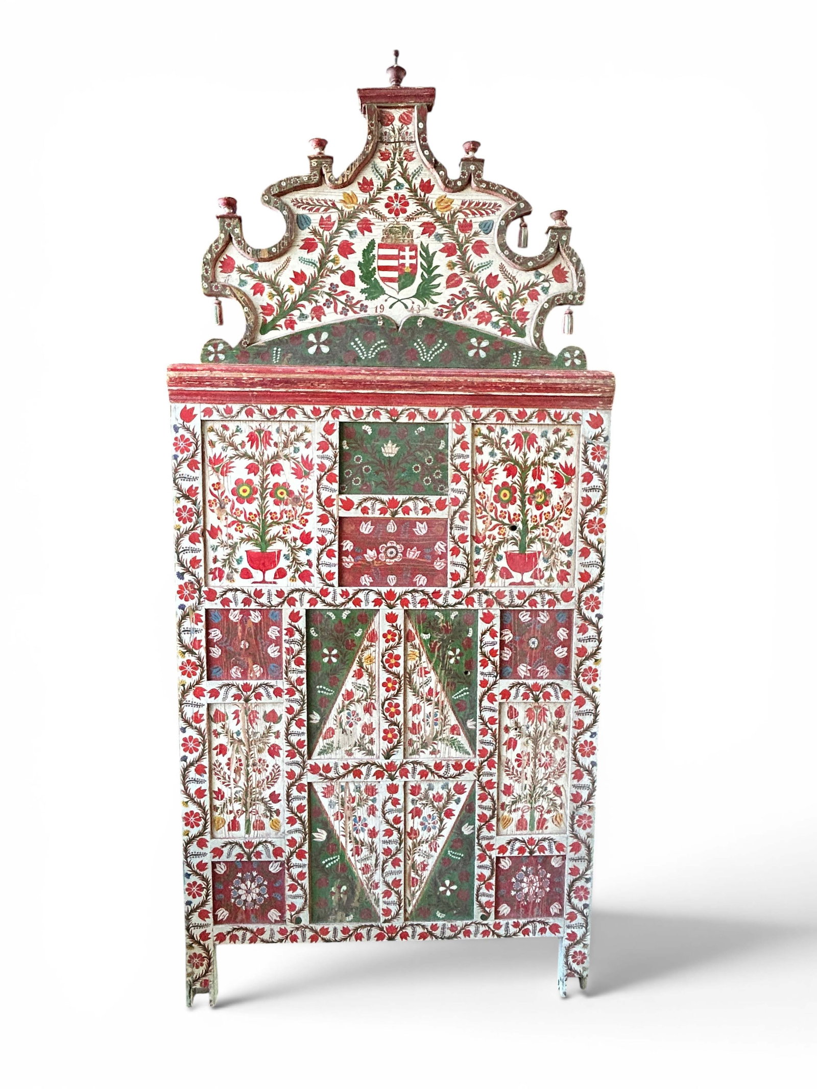 Transylvanian ? Ornately Painted Marriage Bed End.: The antique Hungarian folk art style carved and painted bed end or headboard ? features a carved pediment, hanging carved tassels, panel style wood overlay, and turned wood finials. The paintings feat