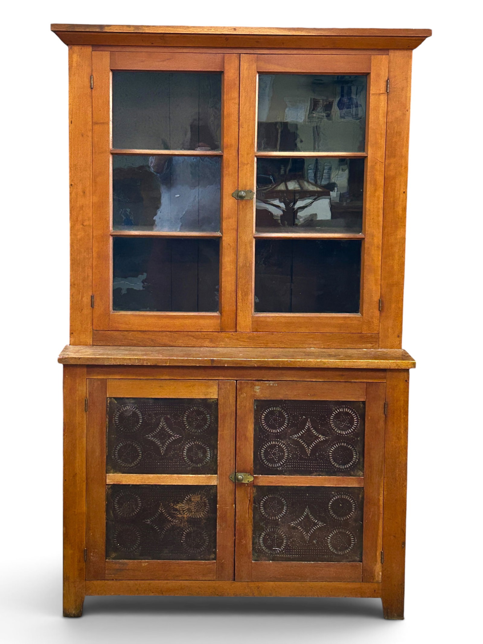 Rustic Step Back Cabinet with Pie Safe.: The top half of this cabinet has glass paneled doors with a brown painted interior and two fixed shelves. The lower half has tin front doors with a brown painted interior and one fixed shelf.