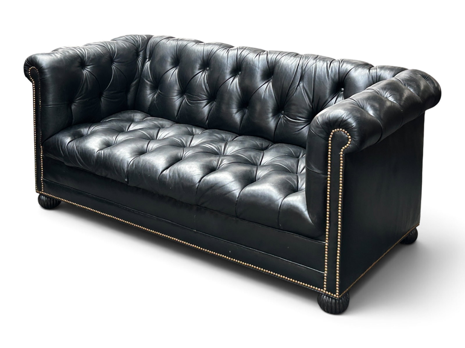 Black Leather Chesterfield Sofa.: The sofa has button tufted black leather and nailhead trim. One of the buttons is missing on the back, and there is some dirt. Overall the sofa is in great condition and is very comfortable. it measur