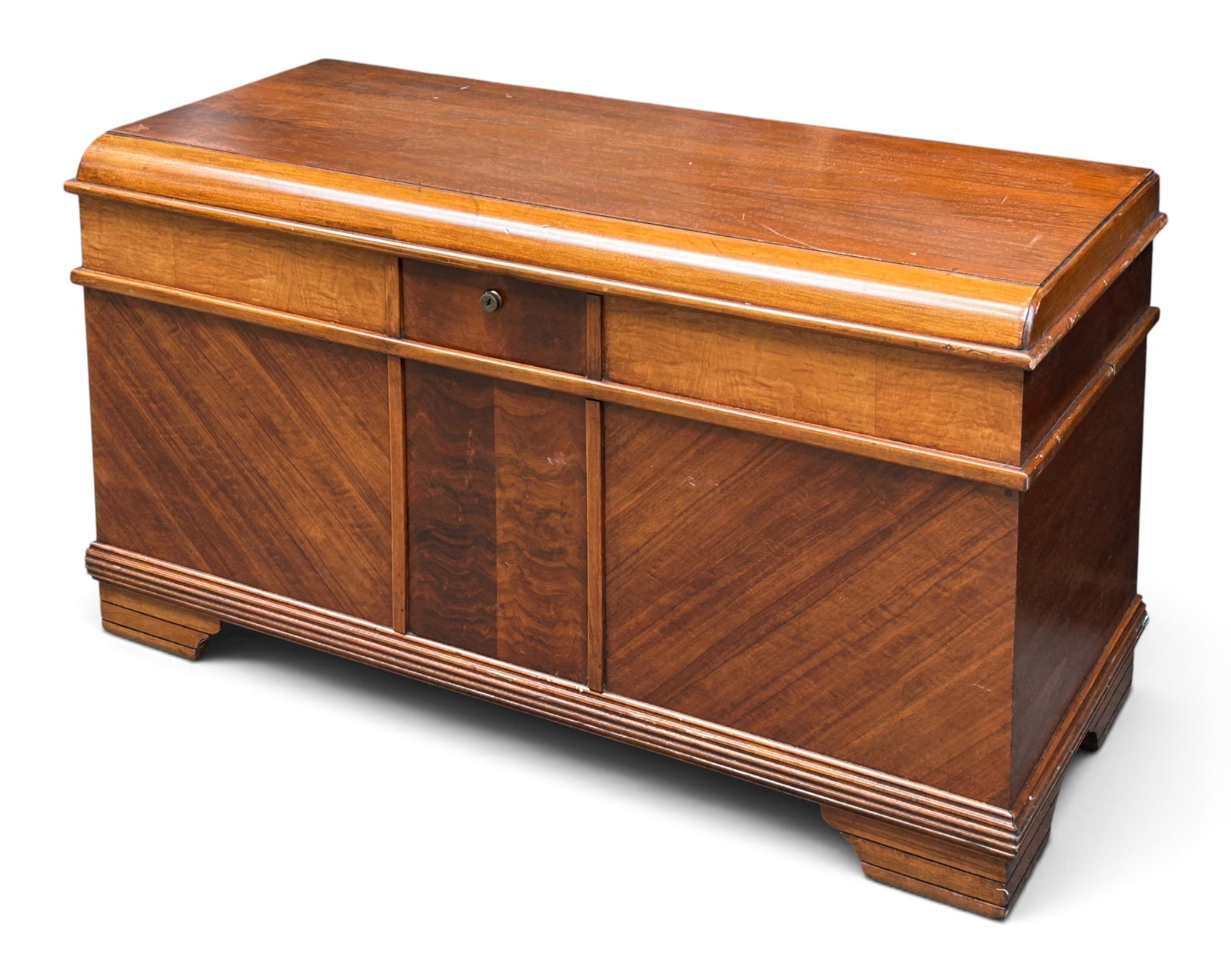 Caswell-Runyan Art Deco Waterfall Cedar Chest.: The chest features a curved top, diagonal light and dark wood designs, a lift top, 2 tray compartments, and a lower storage area. It has the original label. It measures 24" tall, 44" wide, and 18" dee