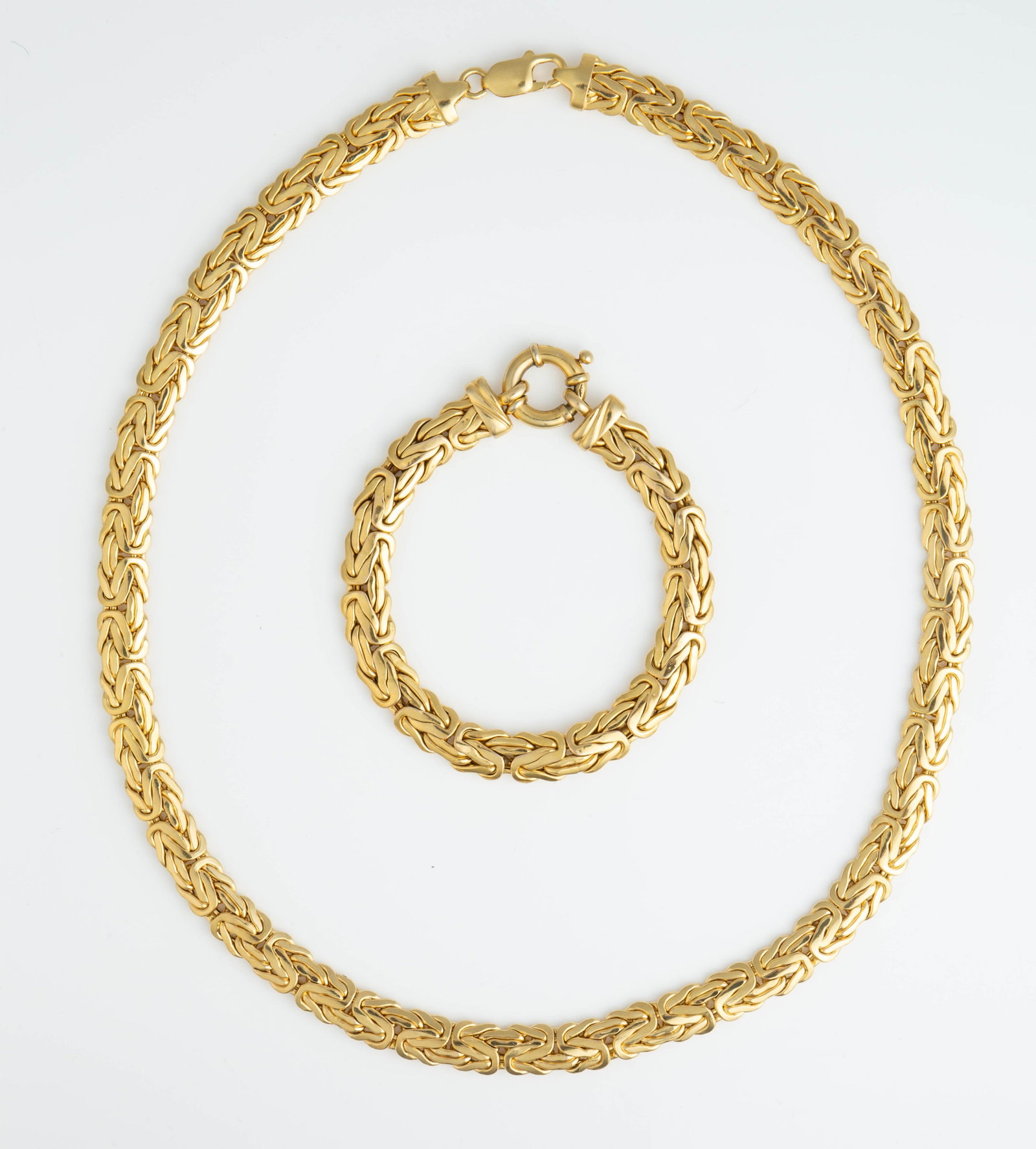 14K Yellow Gold Byzantine Chain Set - 44 DTW.: The lot contains a matching necklace and bracelet. The 14K stamp and maker's mark are more clear on the necklace than the bracelet, but both items are marked. The necklace measures 20 3/8" long and 3/